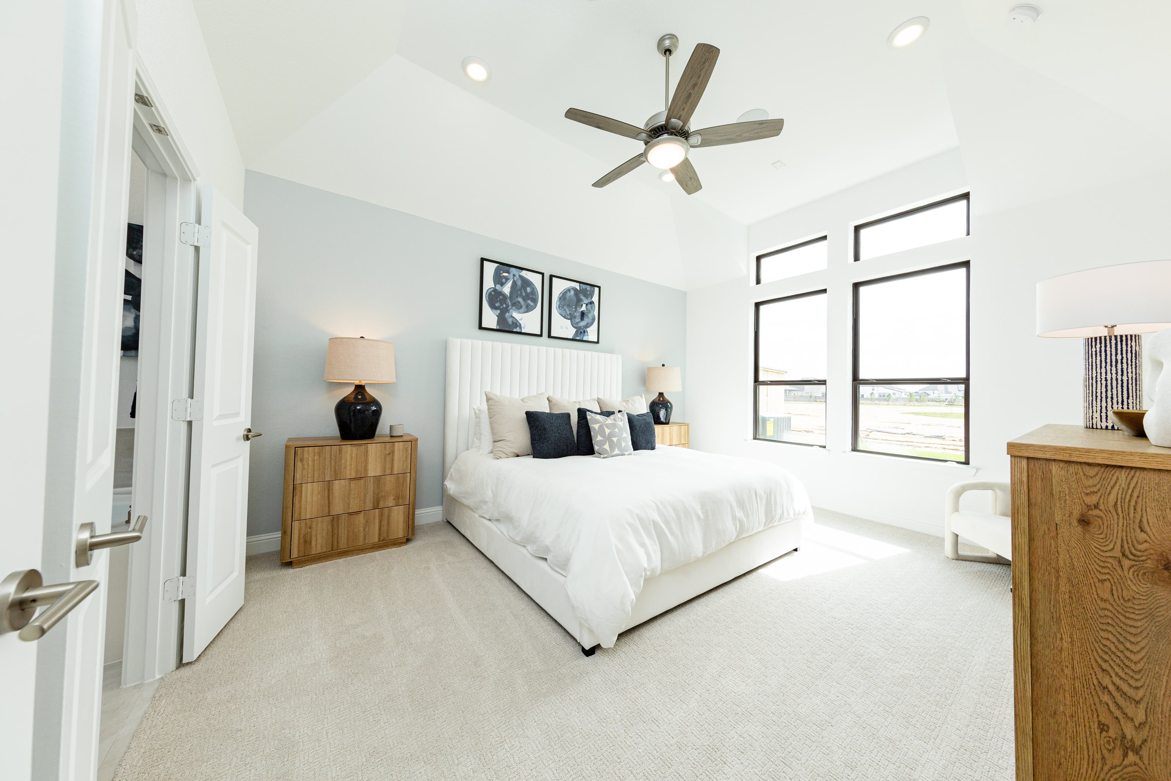 primary bedroom with carpet and windows