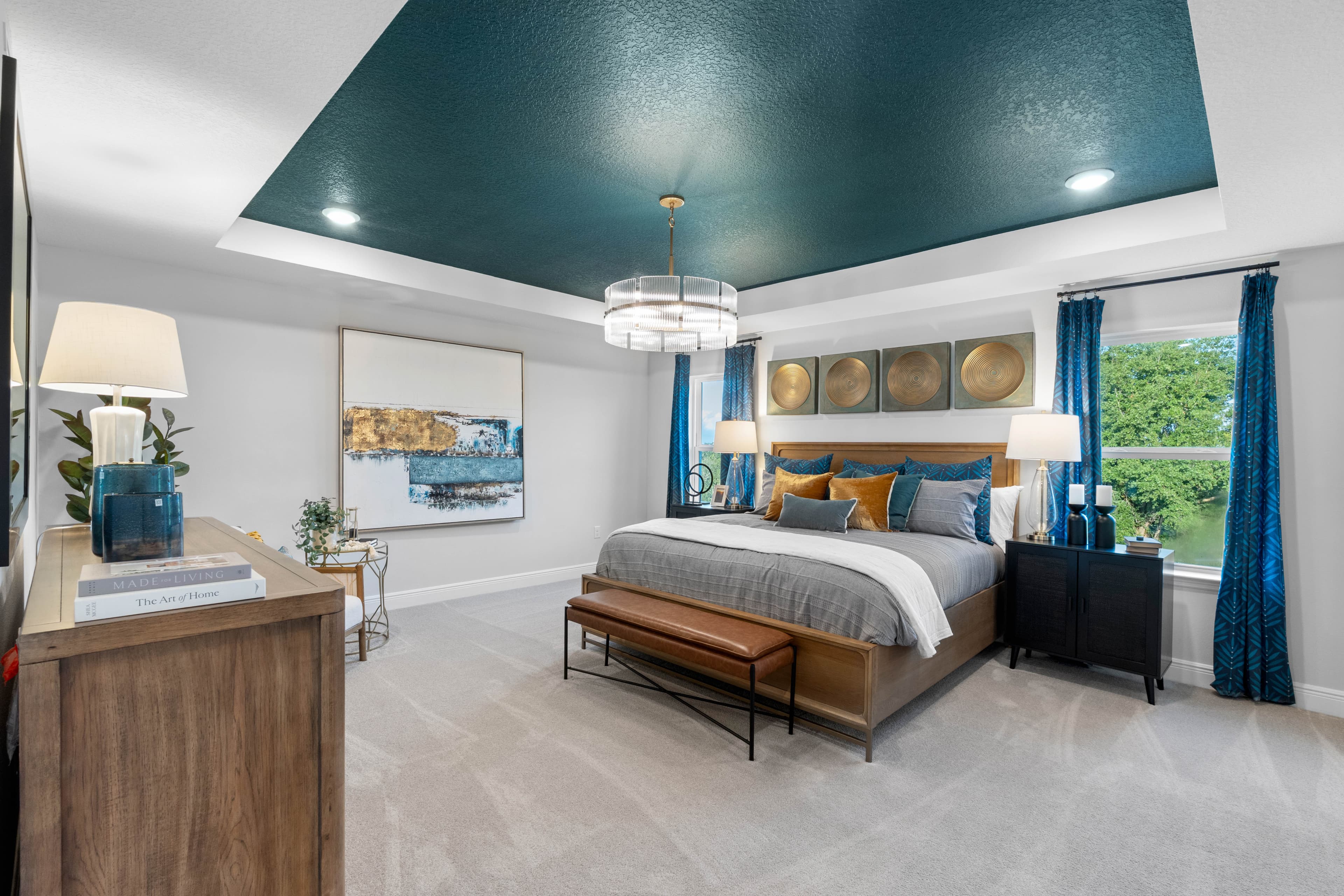 bedroom with multiple windows and access to the primary bathroom