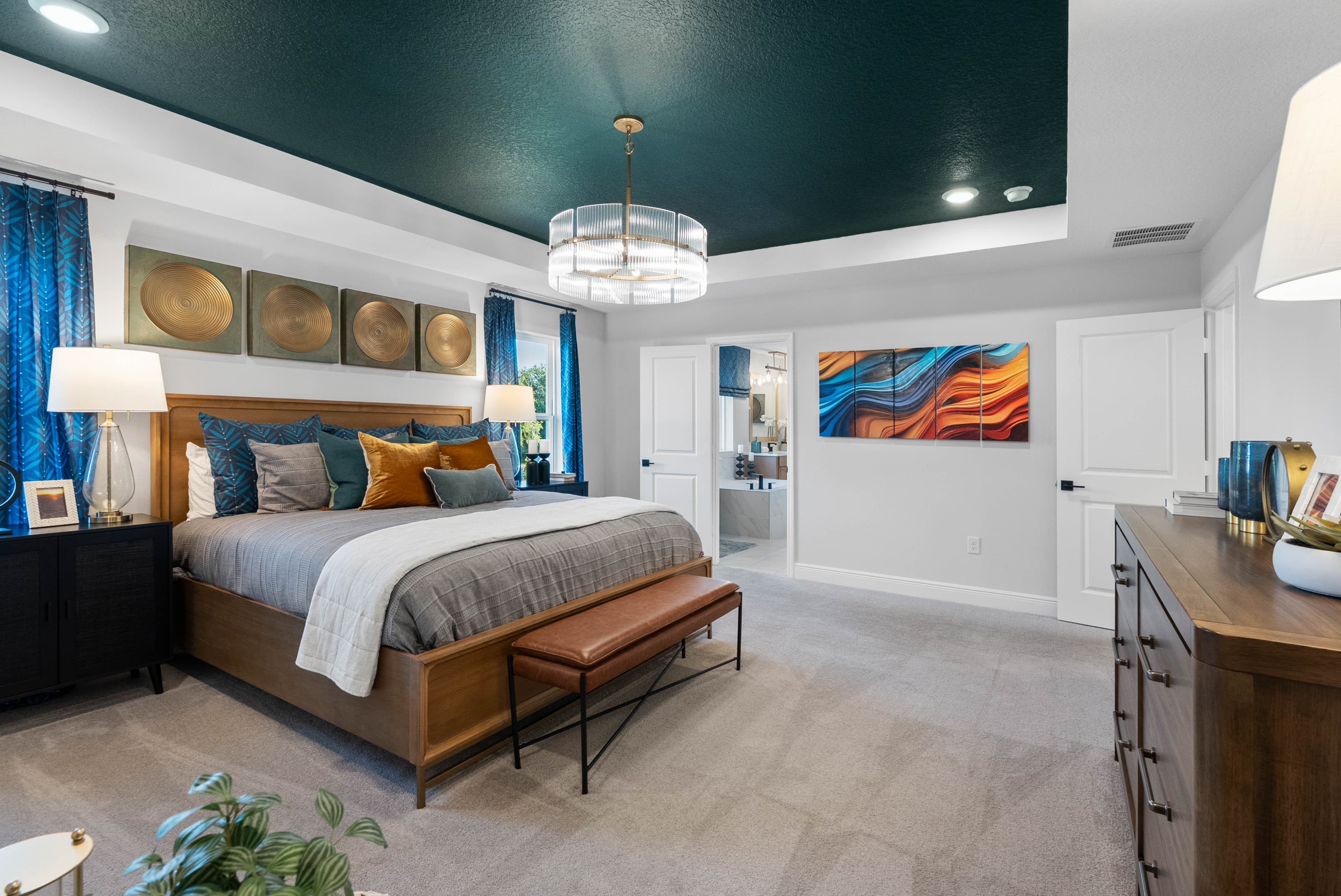 bedroom with multiple windows and access to the primary bathroom