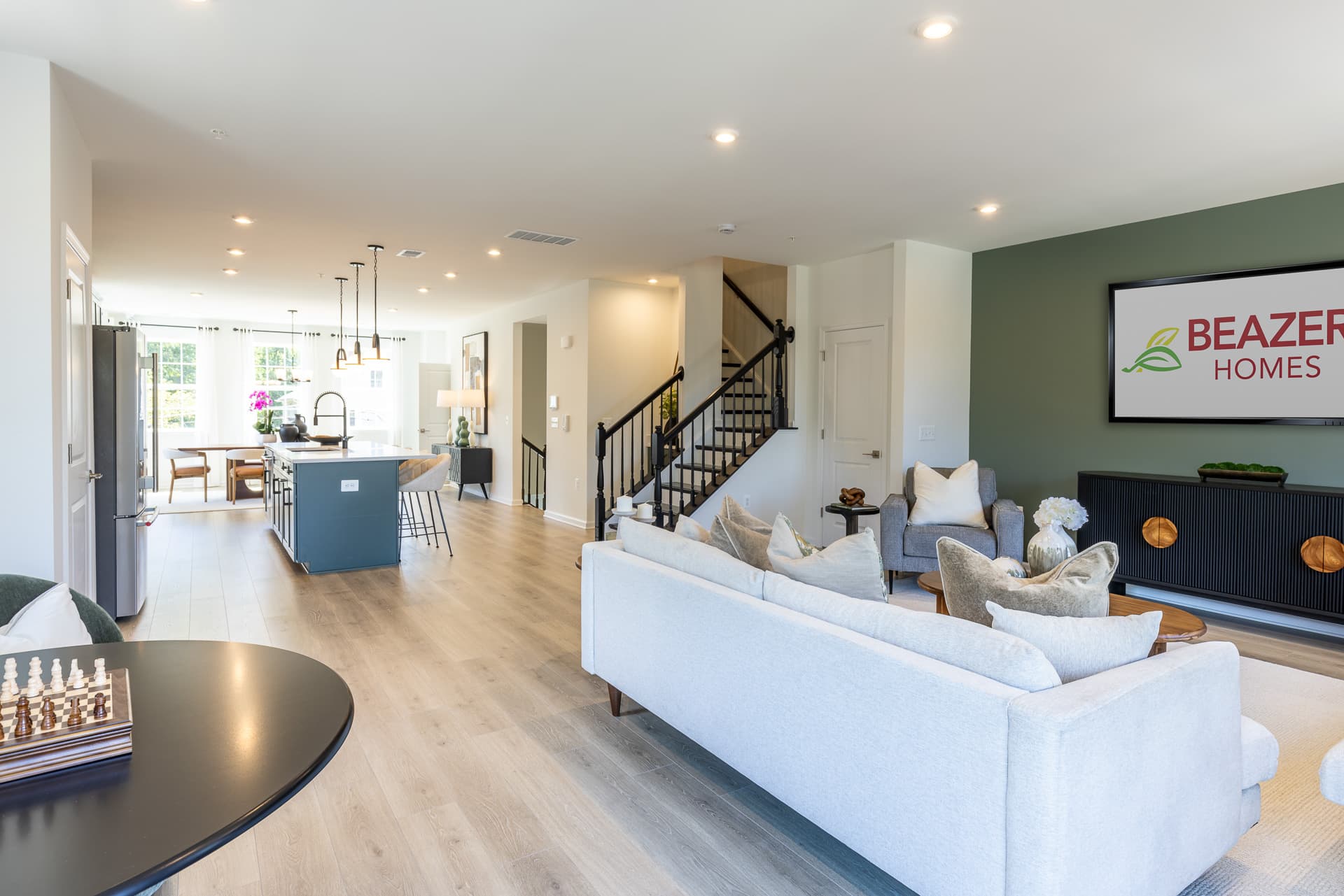 open floorplan with a great room, kitchen, and dining area