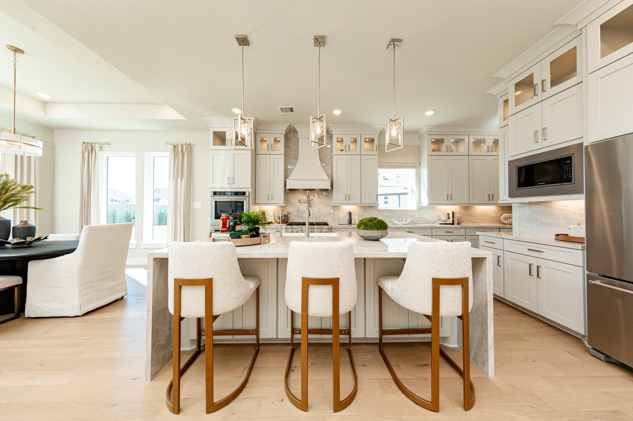 open kitchen with white cabinets and hardwood flooring