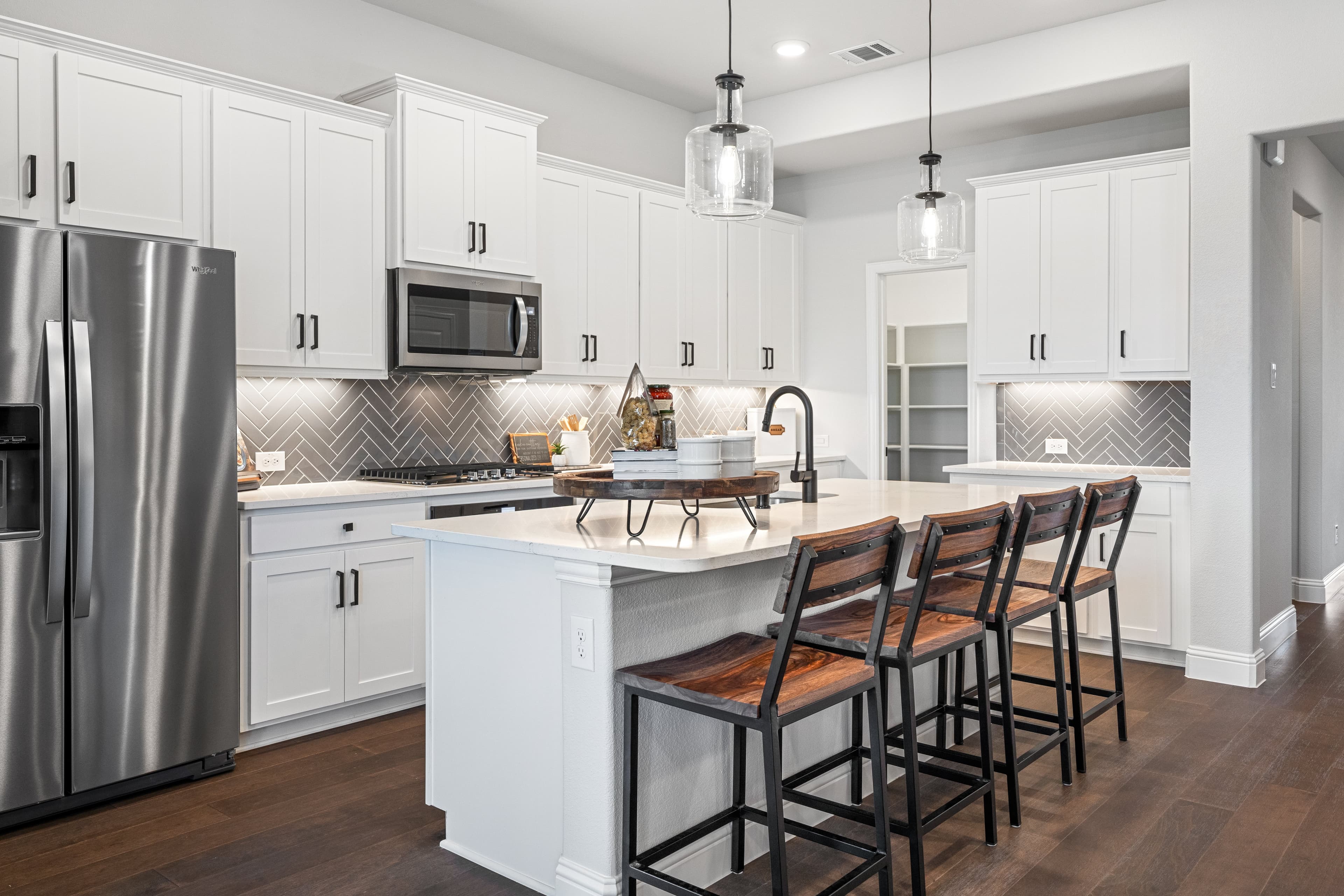 open kitchen with white cabinets and wood floors