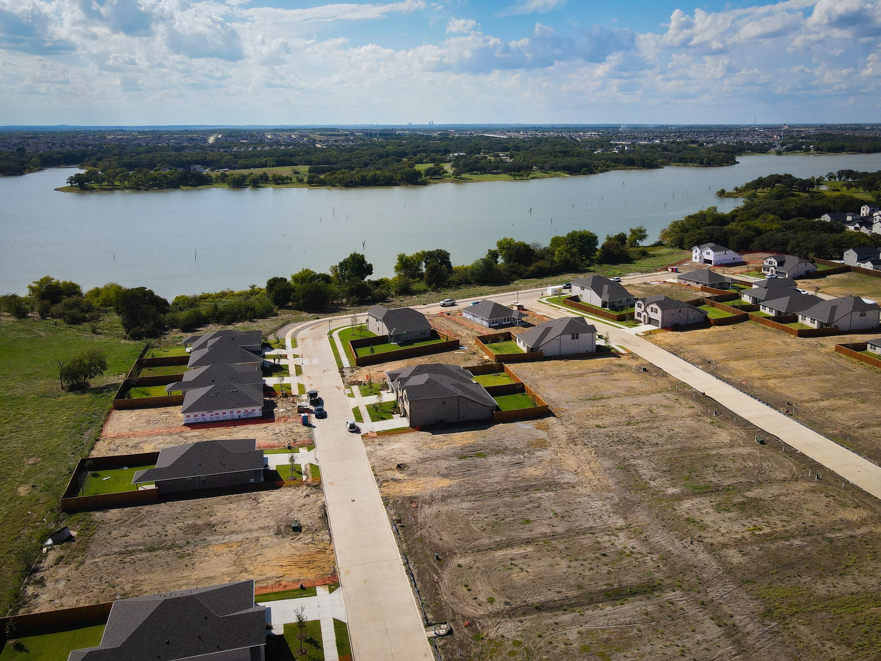 community aerial view with trees and lake