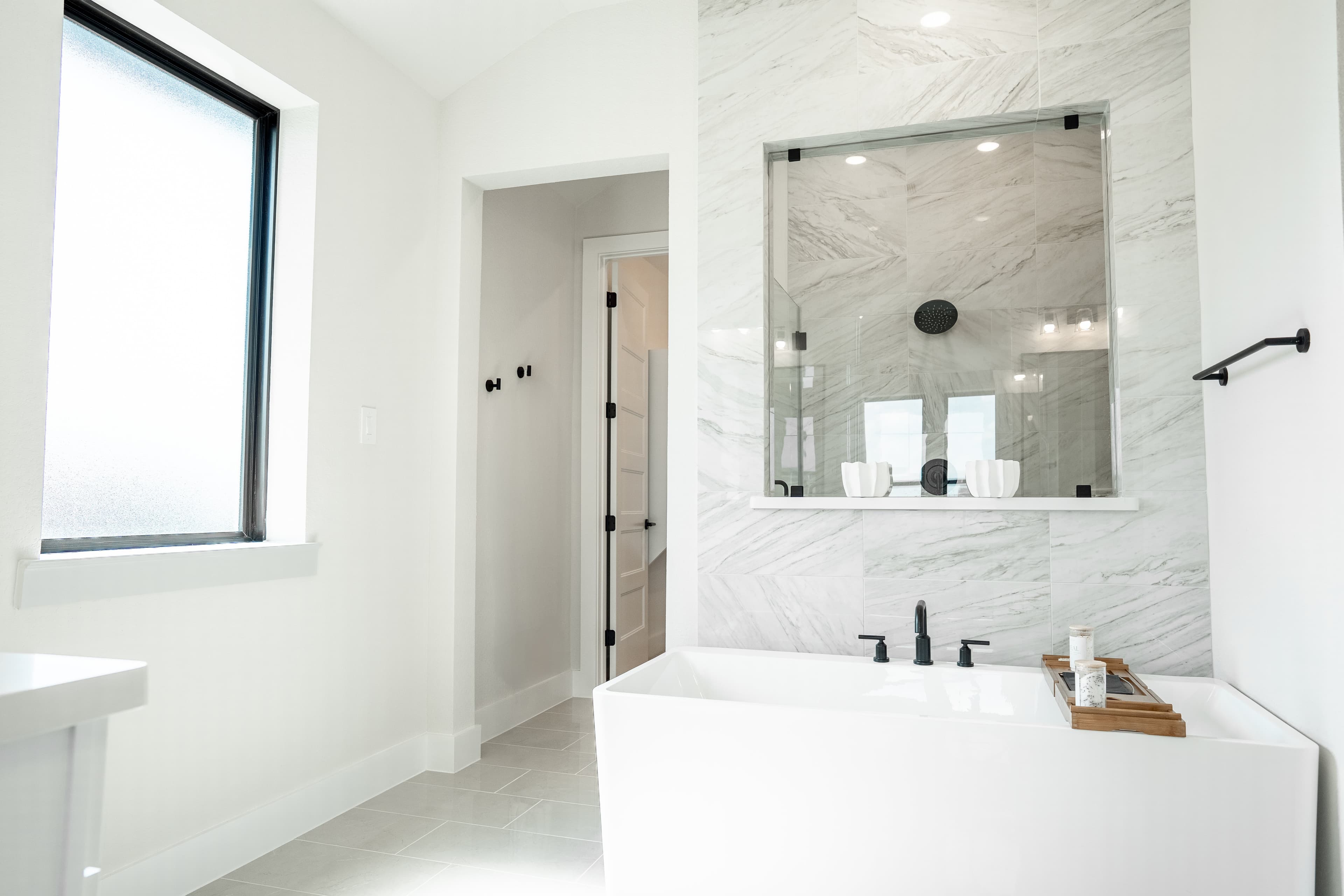 primary bathroom with separate tub and walk-in shower