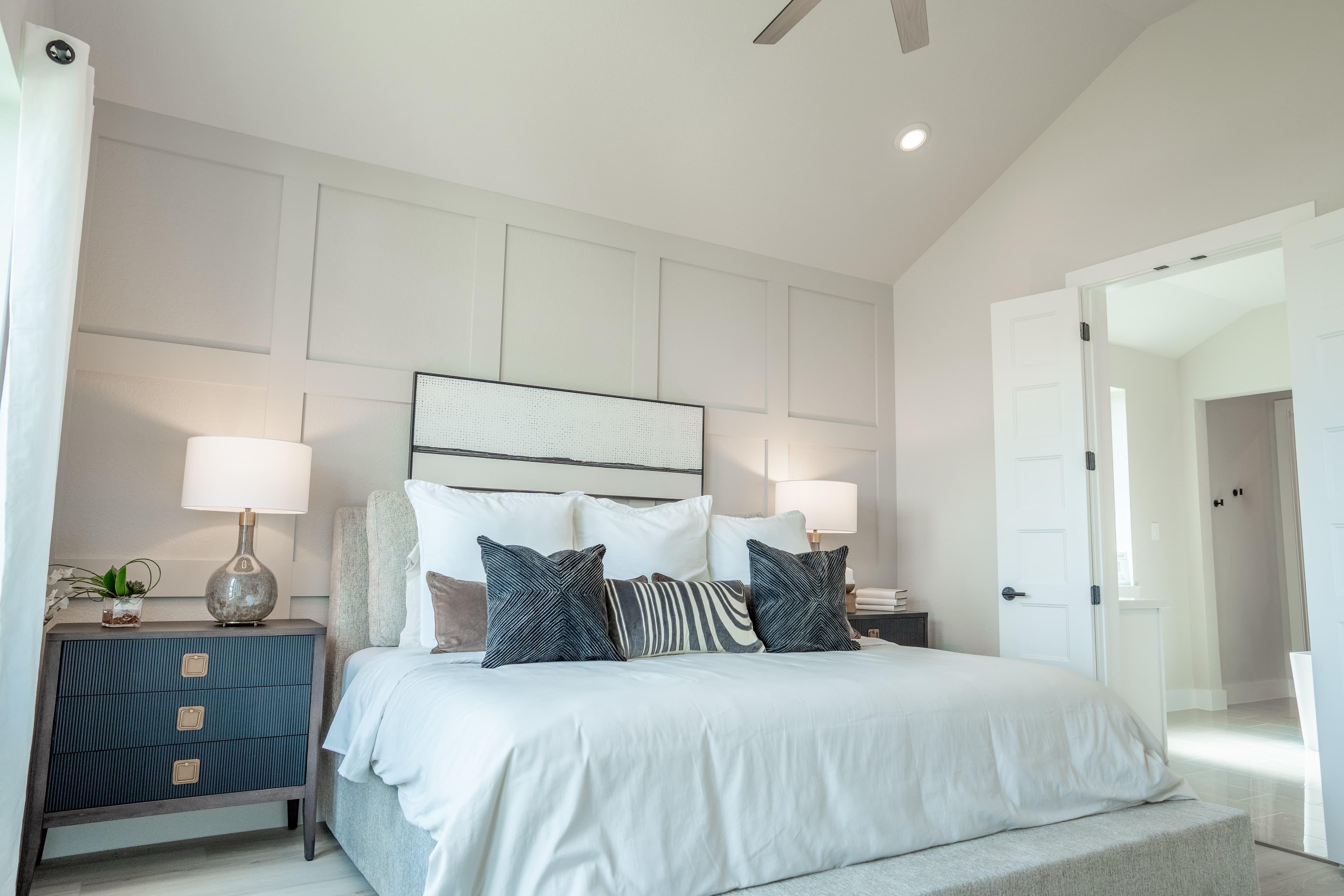 primary bedroom with carpet and vaulted ceilings
