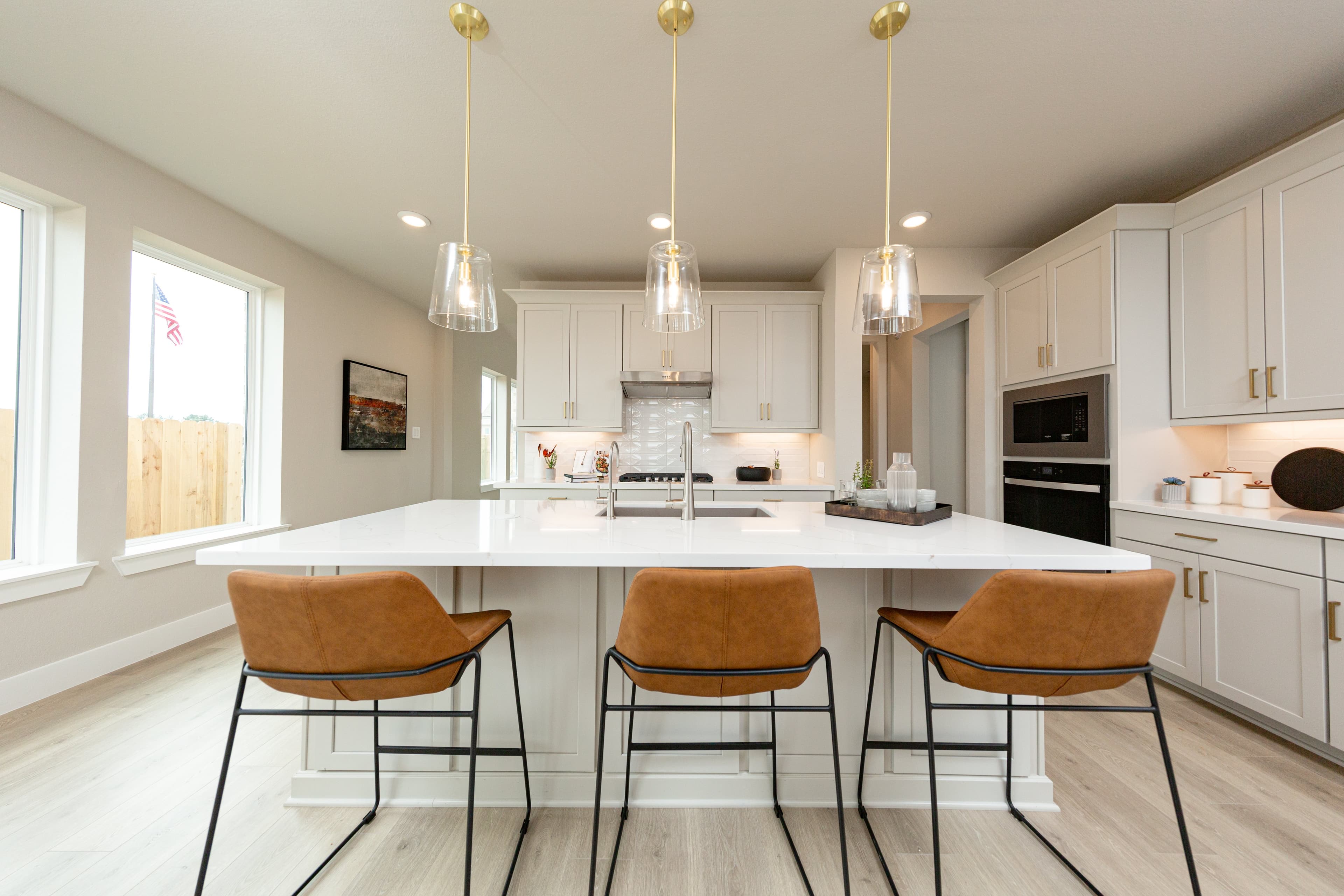 open kitchen with hardwood flooring and beige cabinets