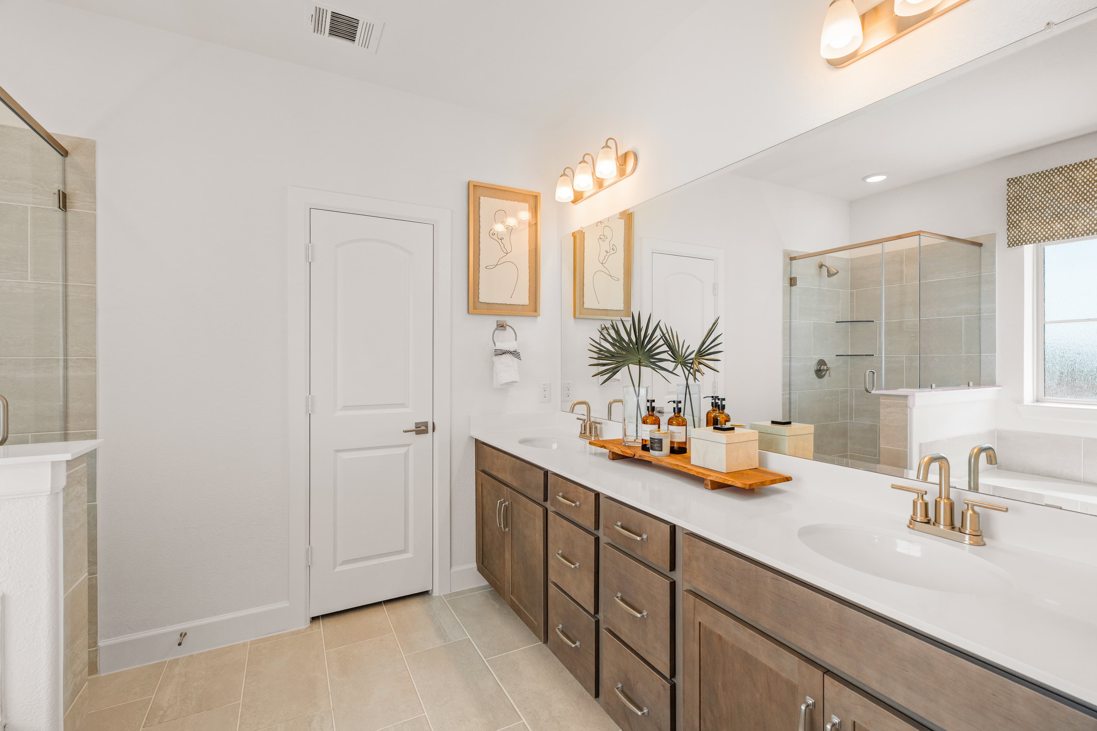 bathroom with large mirror and white countertops 