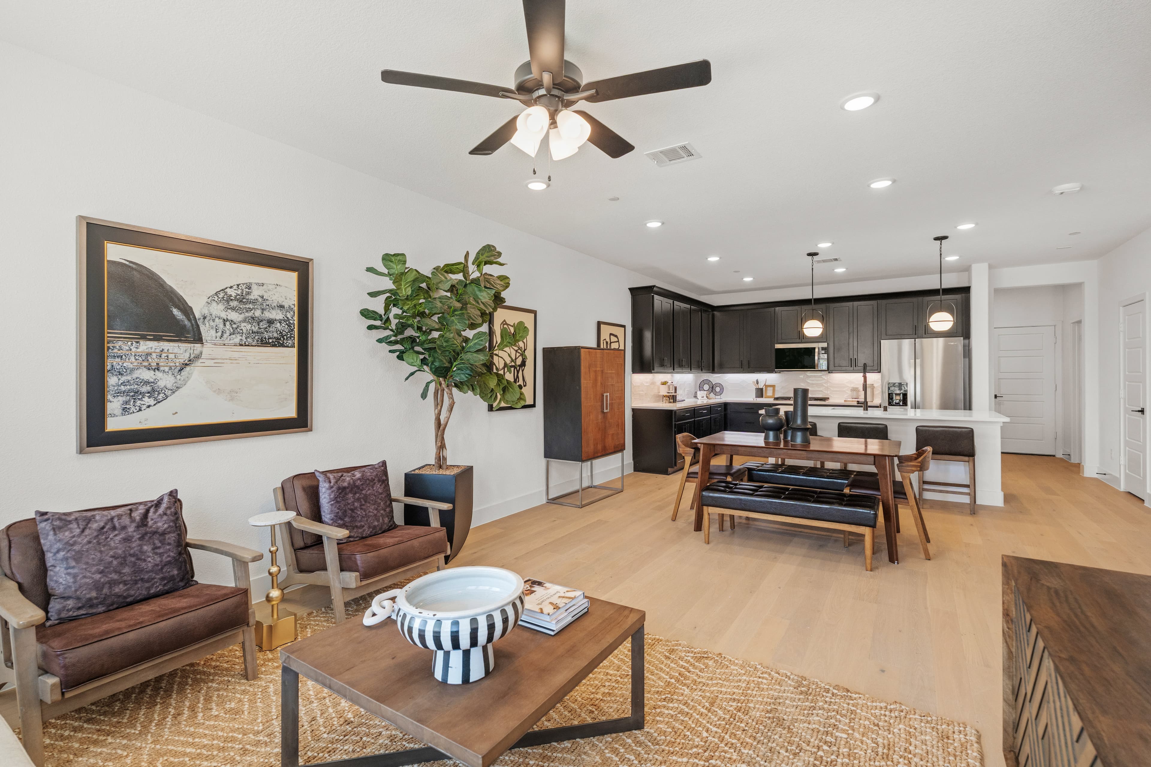 open-concept great room with wood flooring 