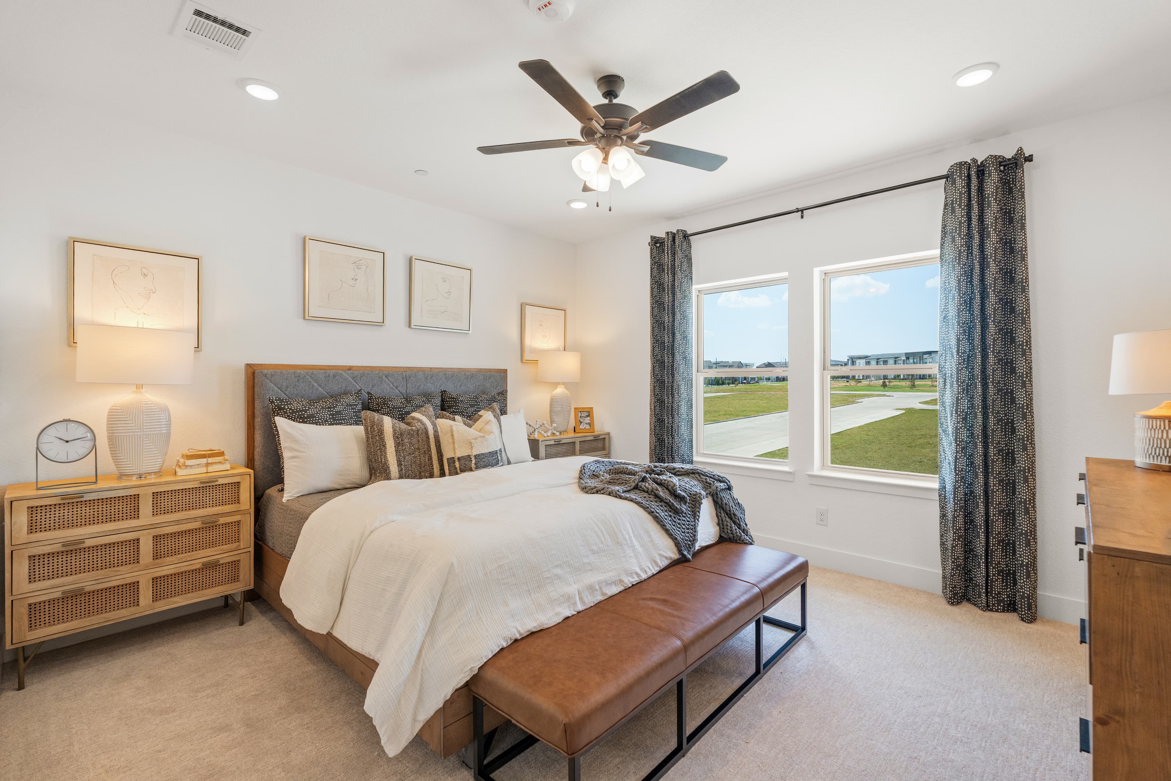 bedroom with large windows and ceiling fan 