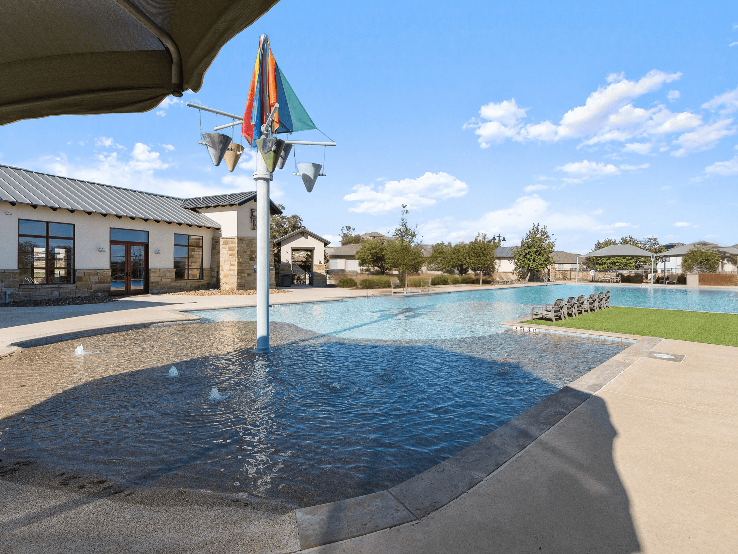 swimming pool with splashpad, amenity center & canopies