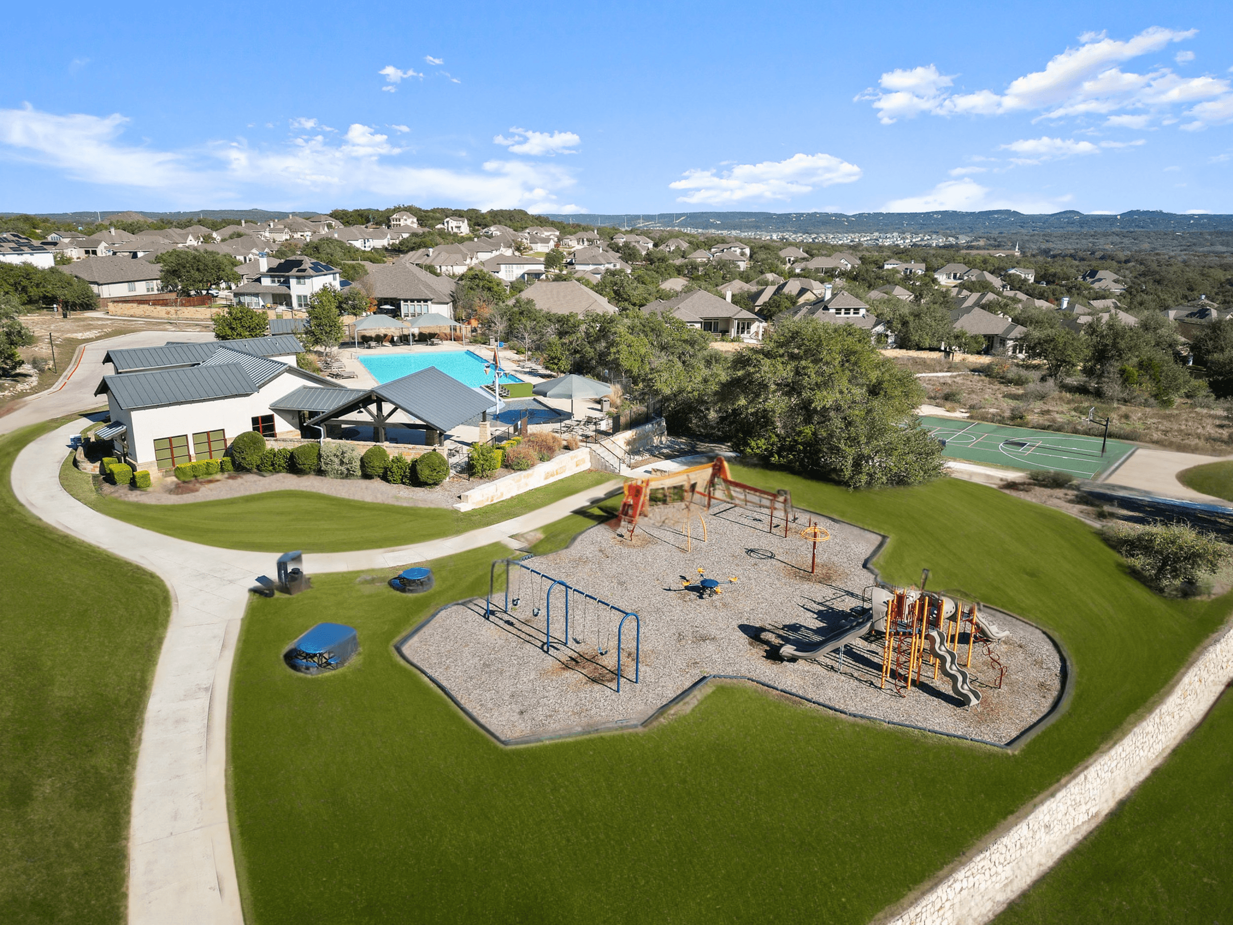 playground with green grass, play set & mulch