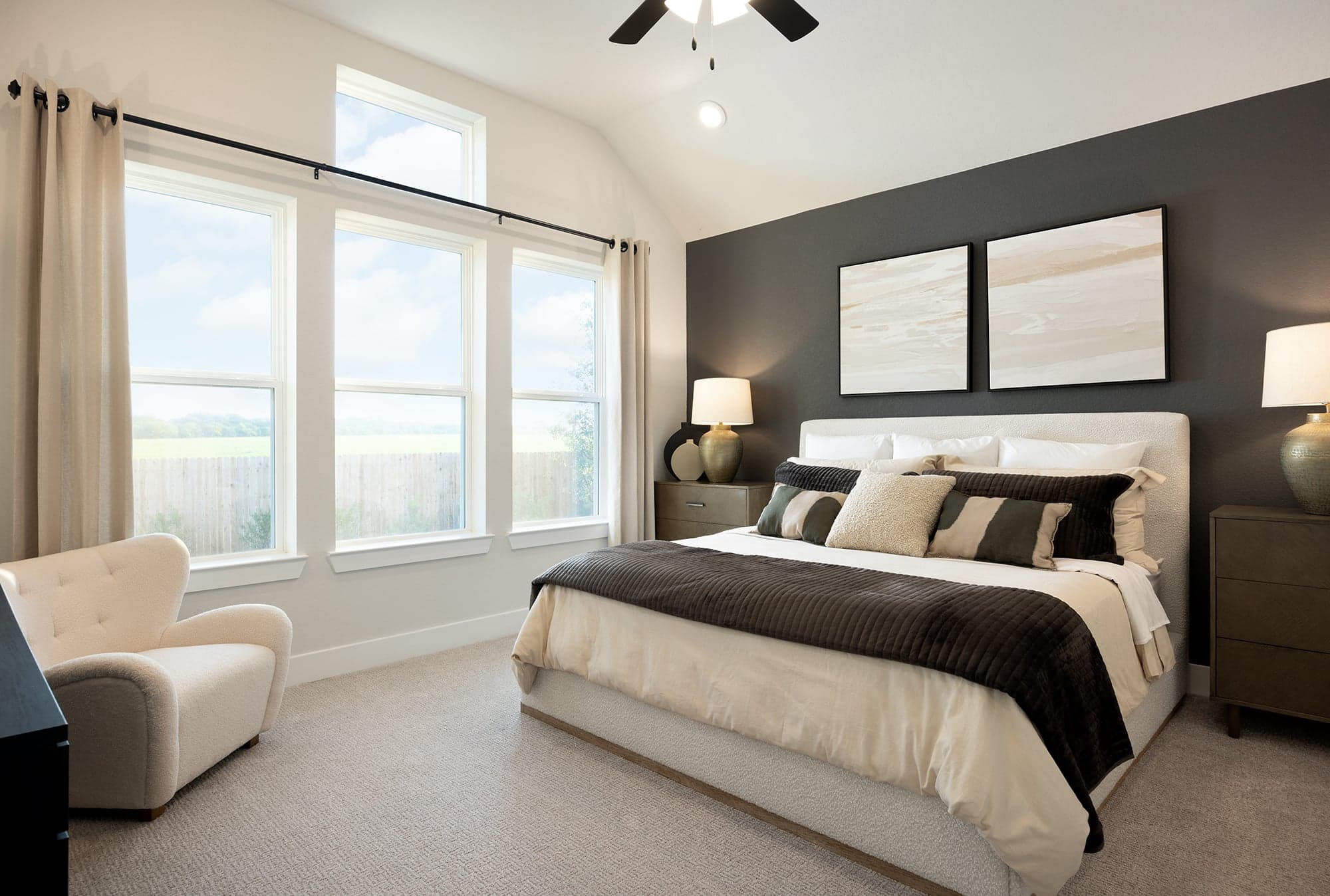 bedroom with carpet, windows & a sloped ceiling