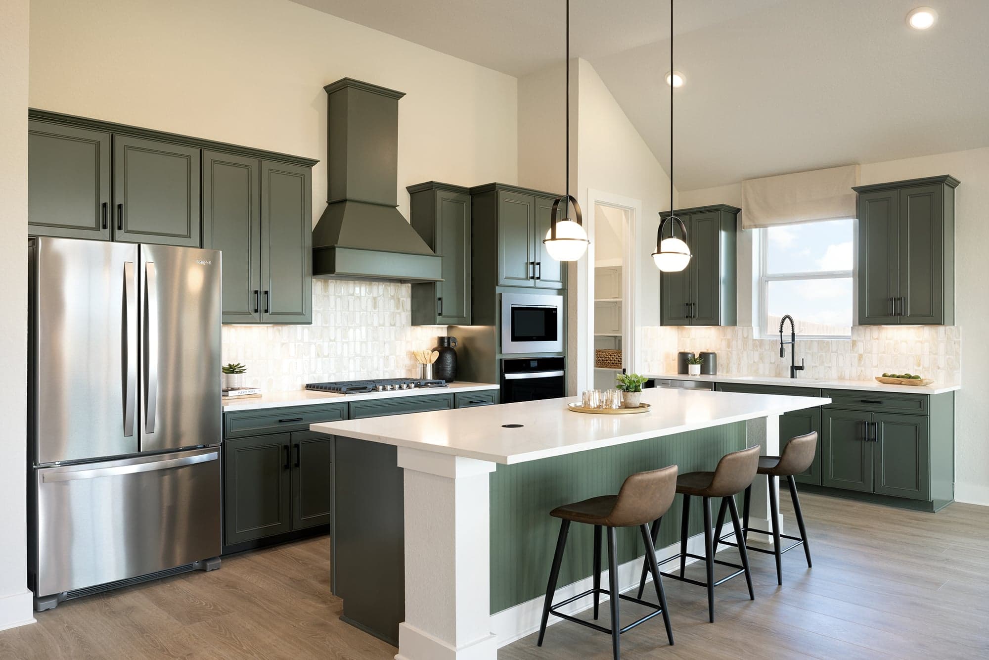 kitchen with quartz countertops, pendant lighting & green cabinets