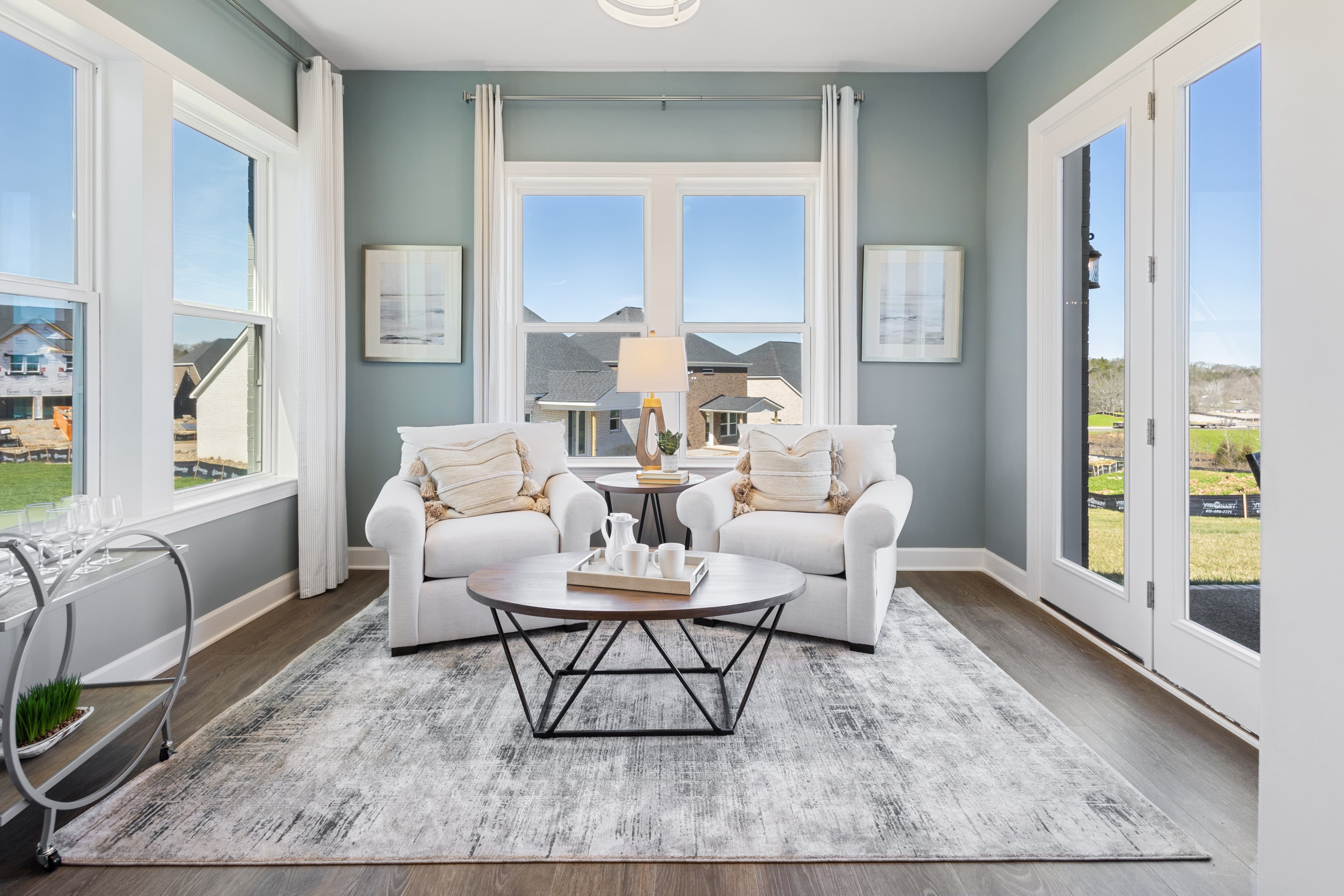 study with wood floors and large windows