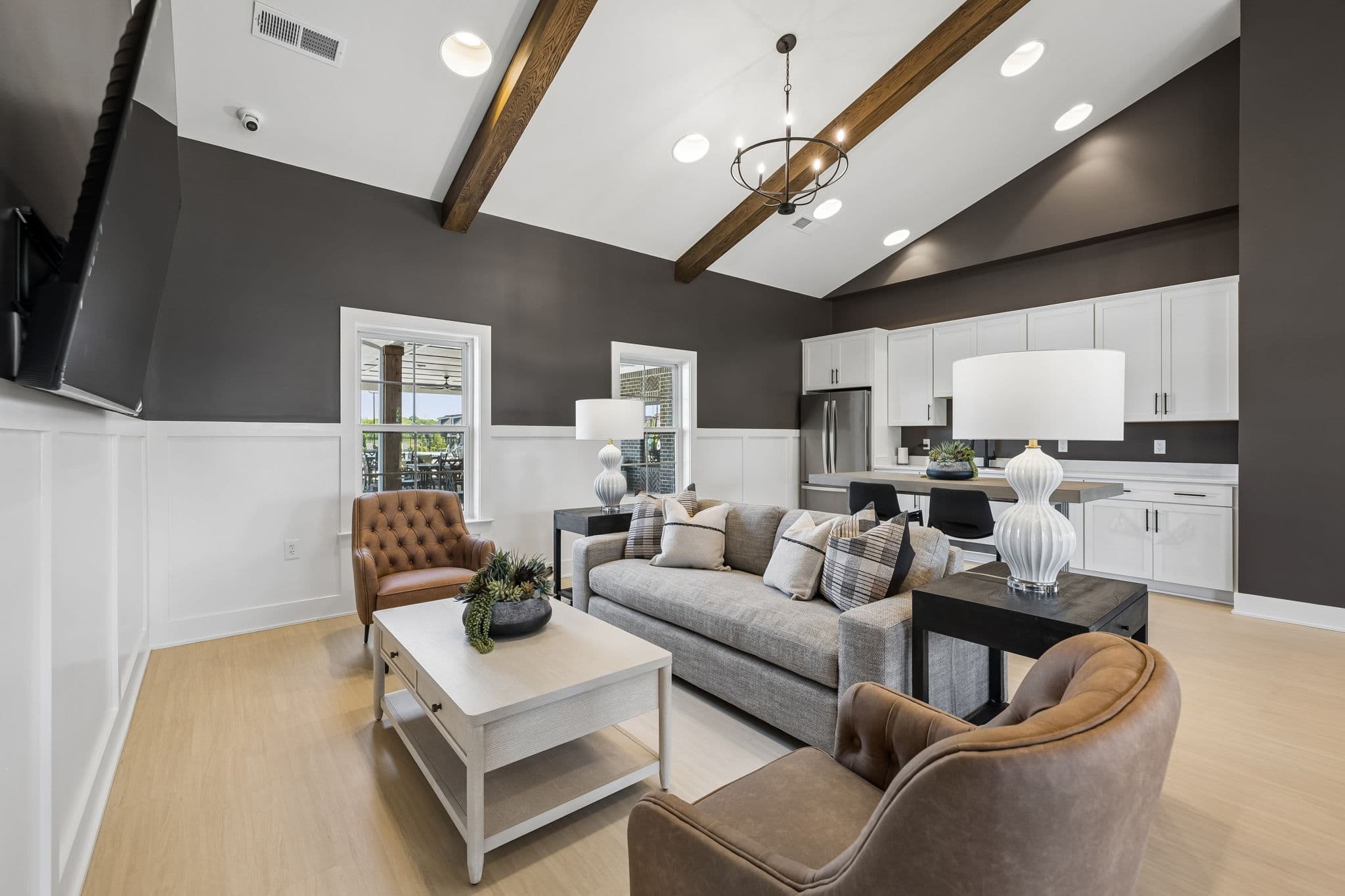 clubhouse with large windows, sitting area, and kitchen with fridge