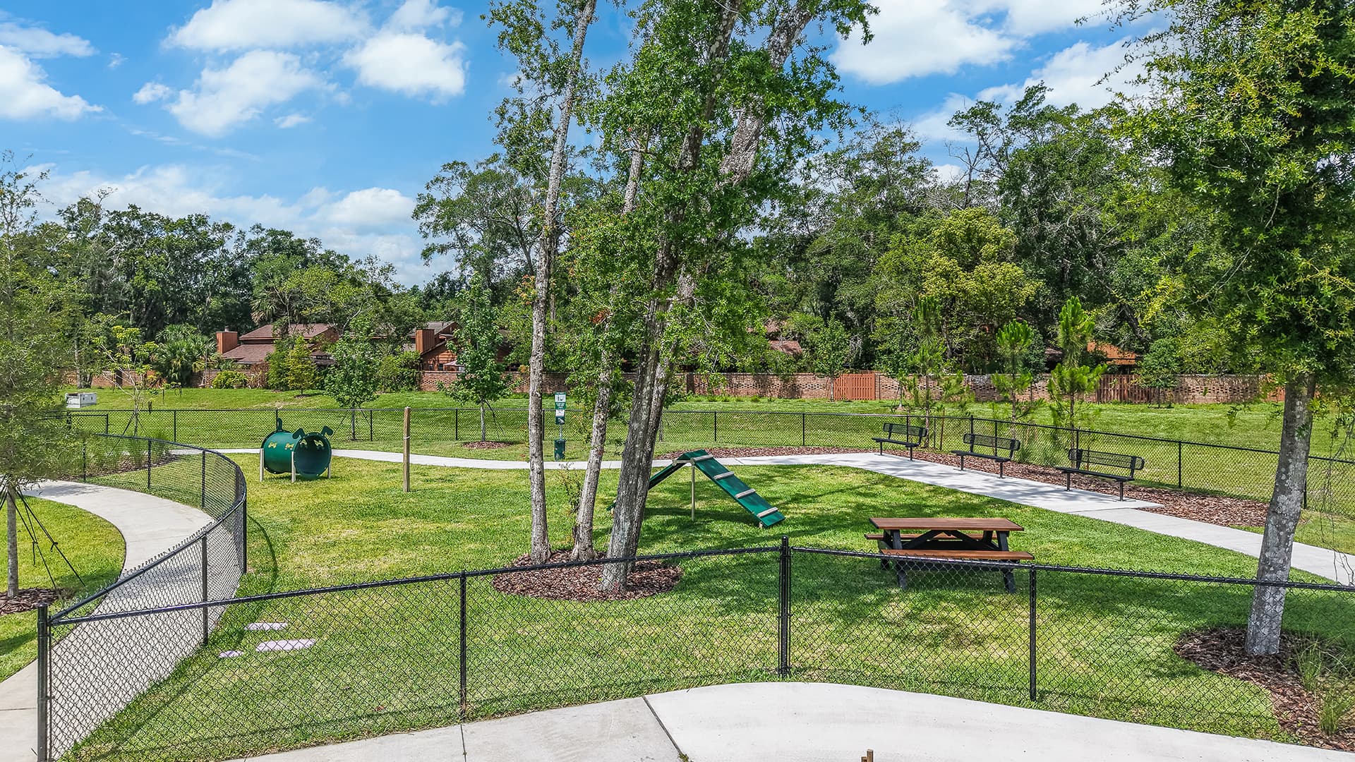 dog park with picnic table and three benches