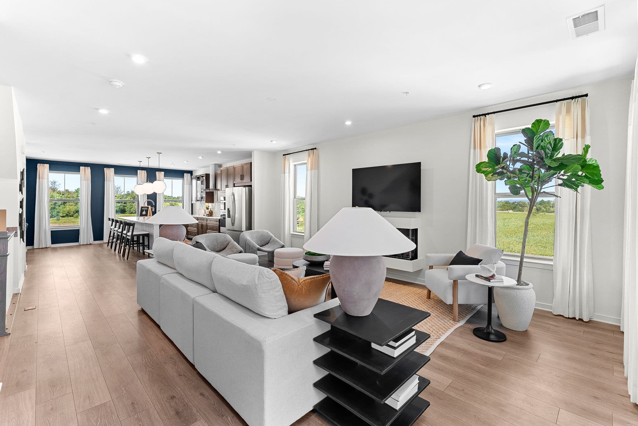 great room with a fireplace and mounted television