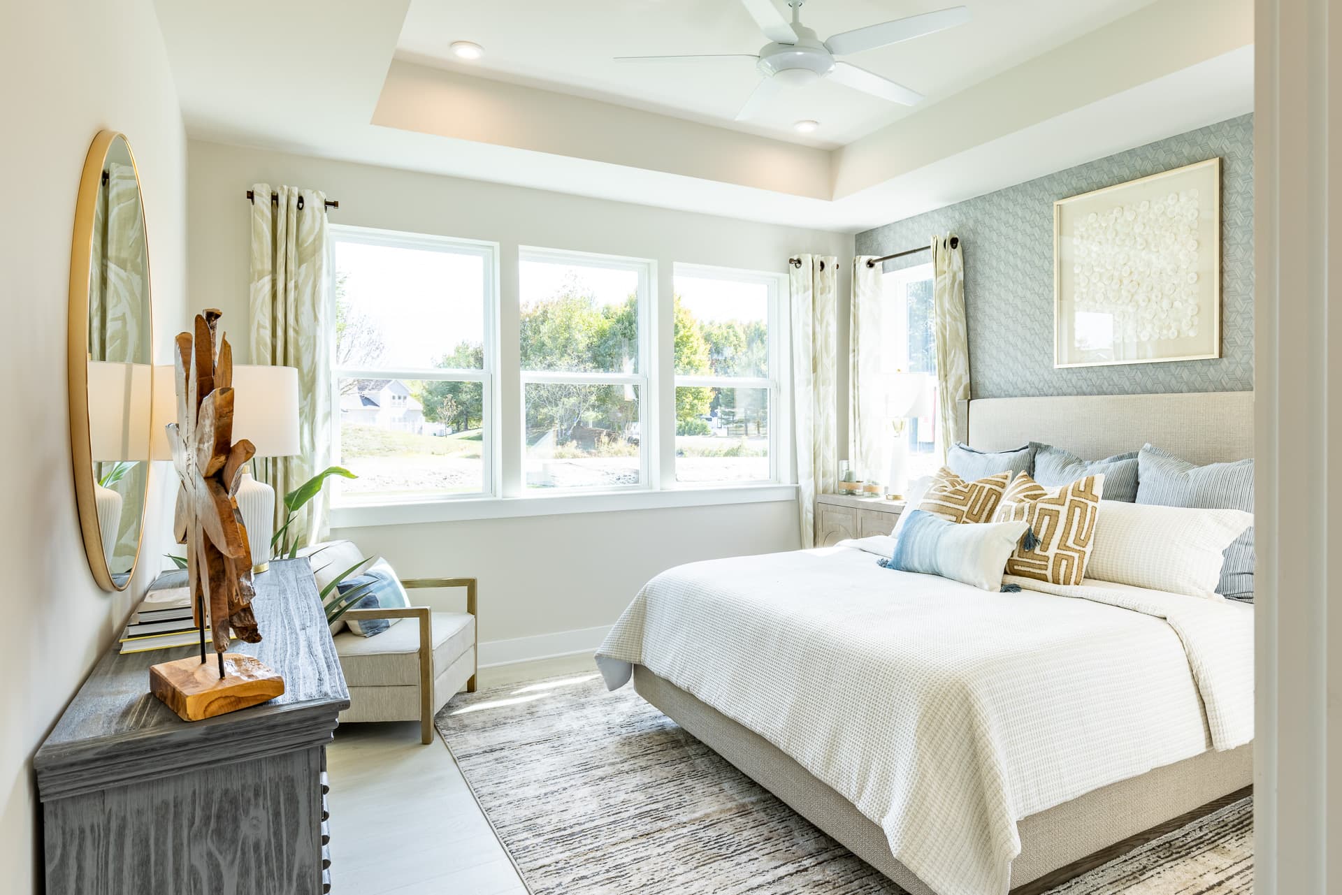 primary suite with a box ceiling and king sized bed