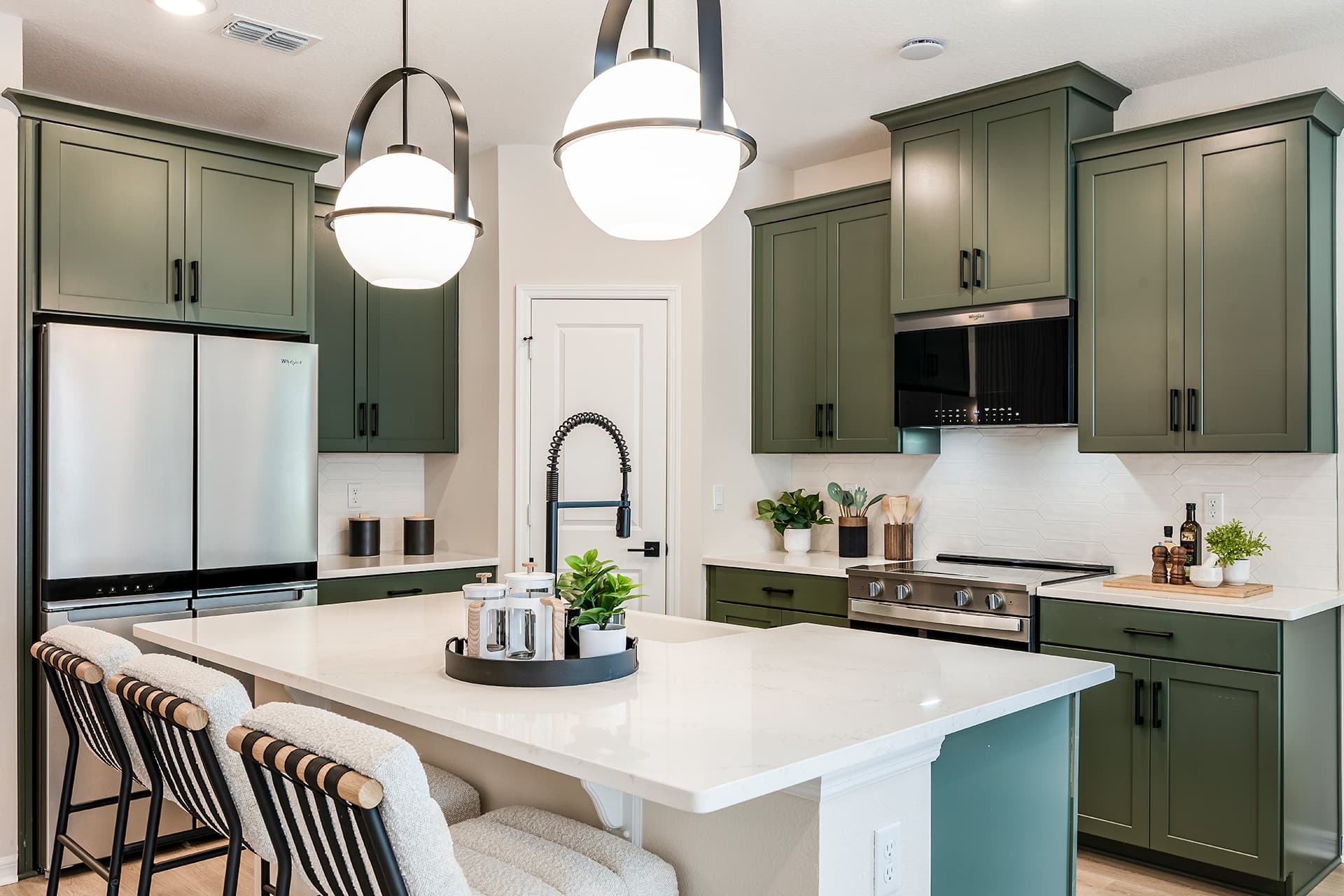 kitchen with green cabinets and quartz countertops