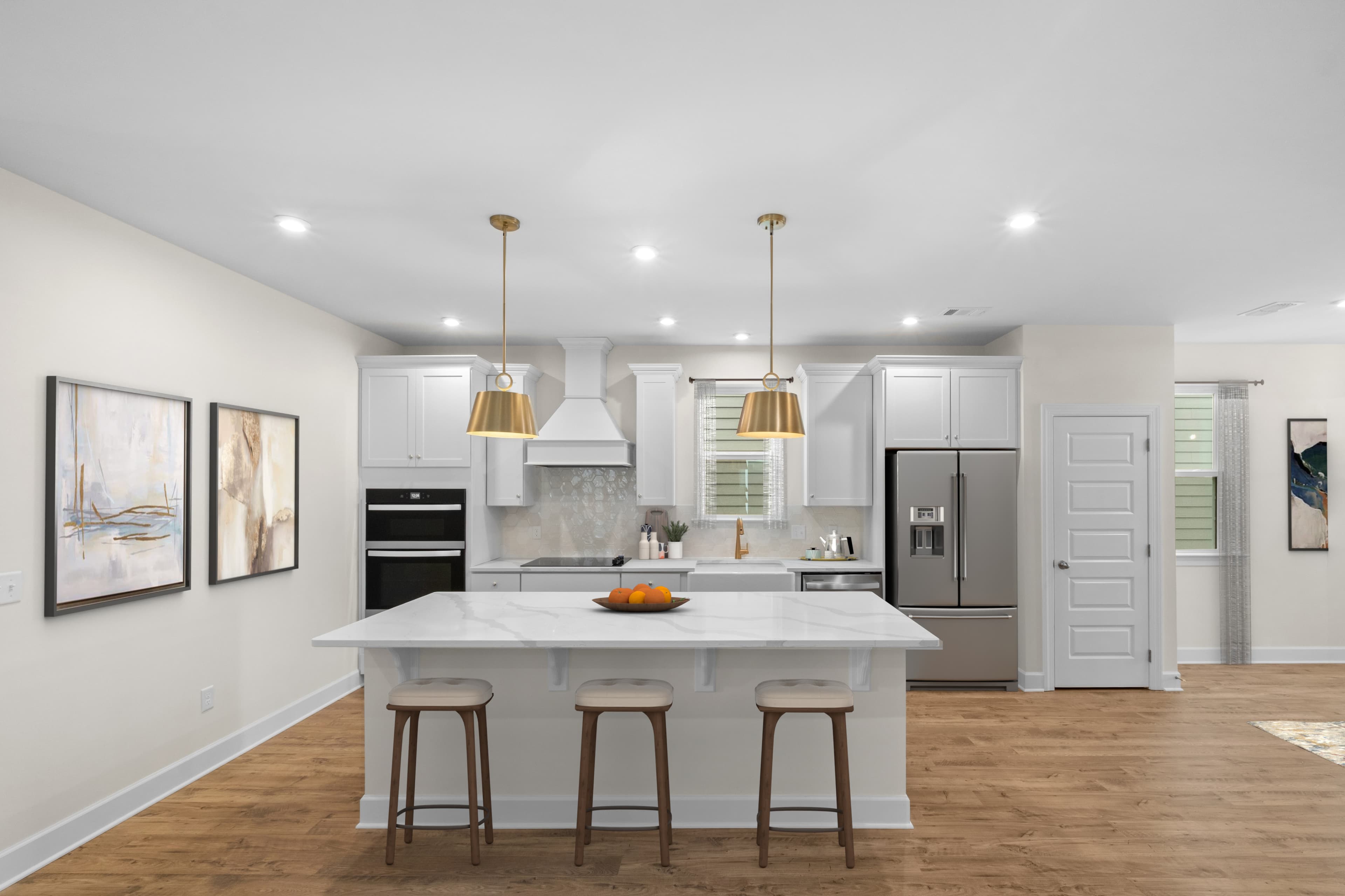 interior photo of kitchen with wood floors and white cabinets