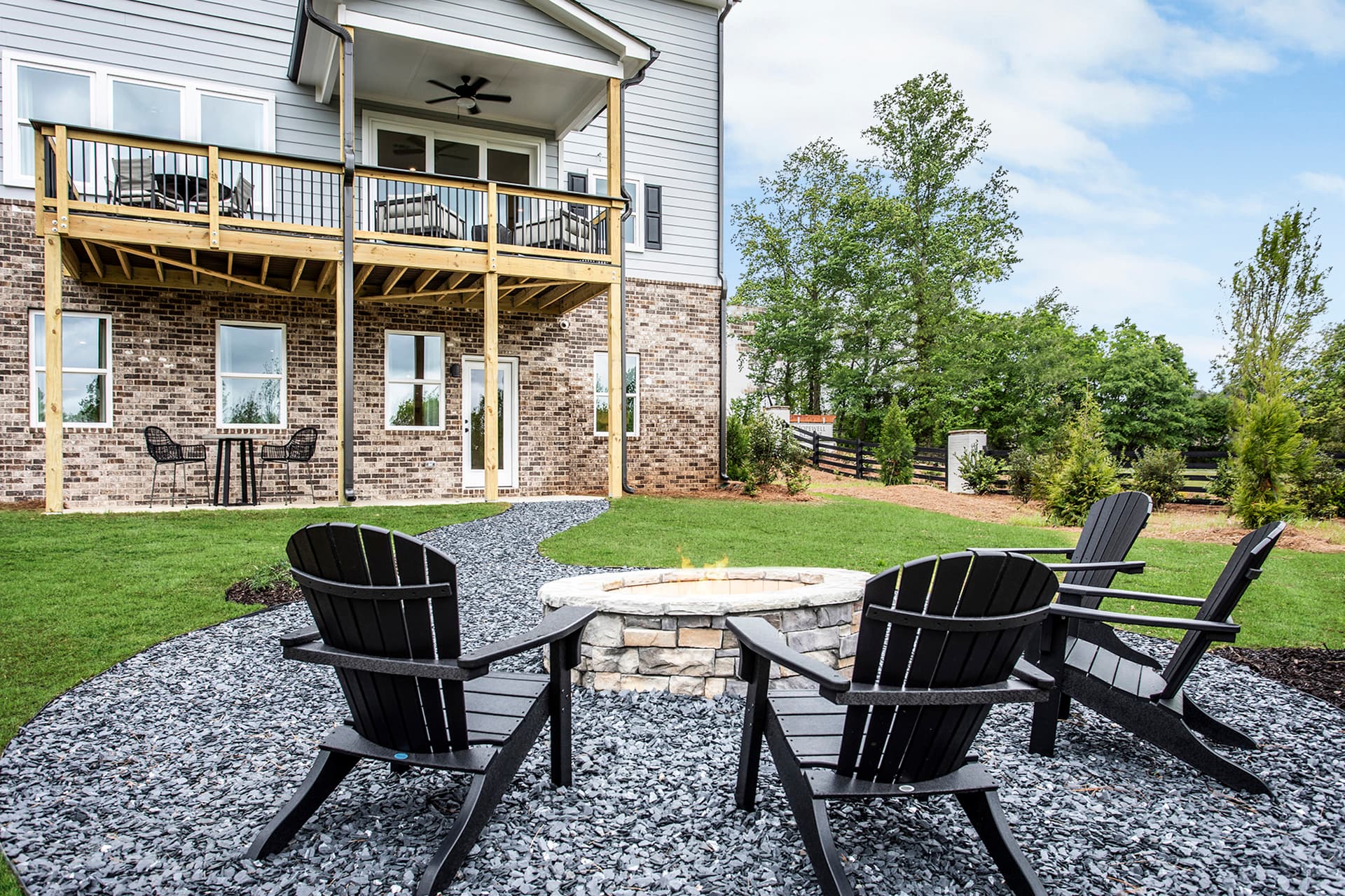 backyard with outdoor fireplace & patio table