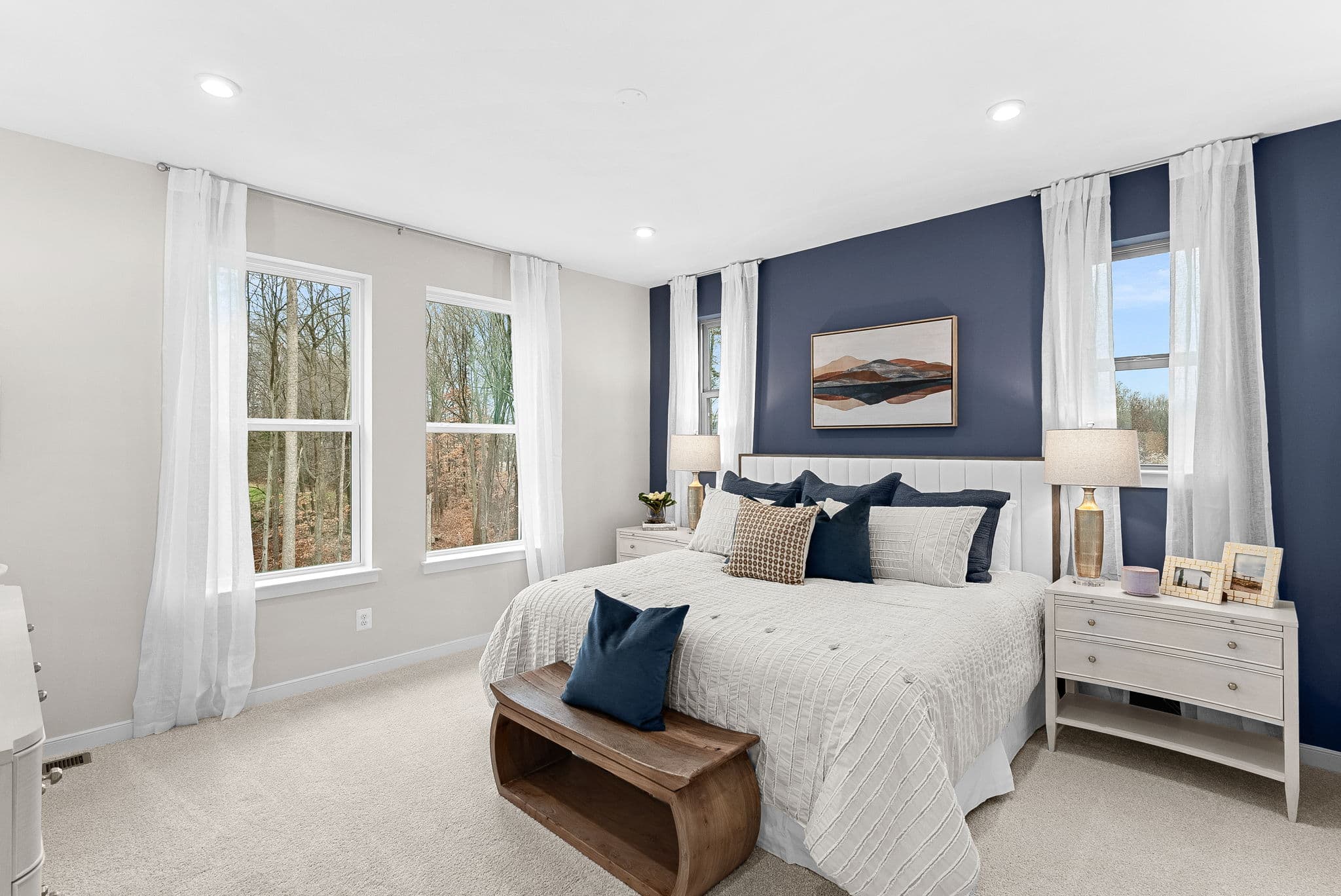 carpeted primary bedroom with 4 large windows