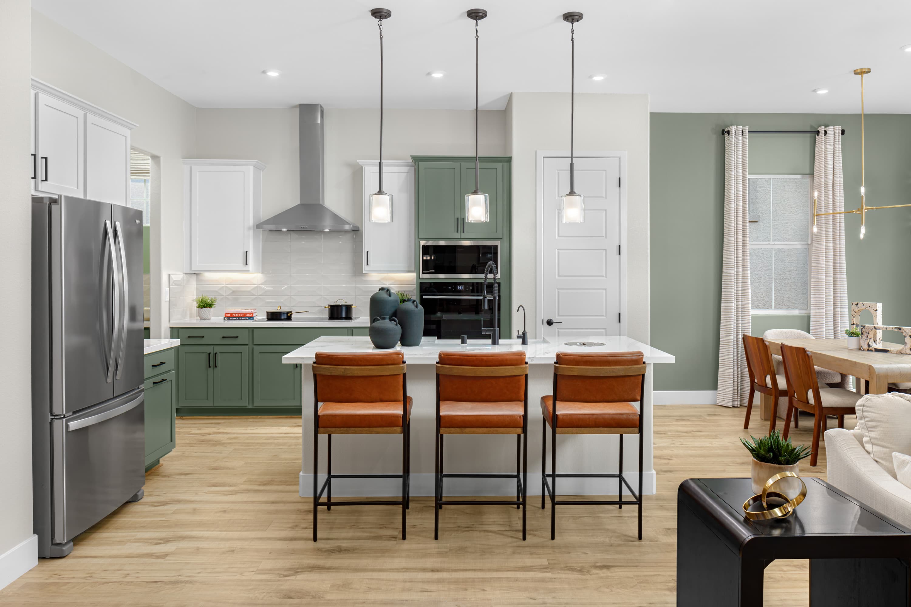 open and airy kitchen with green cabinets