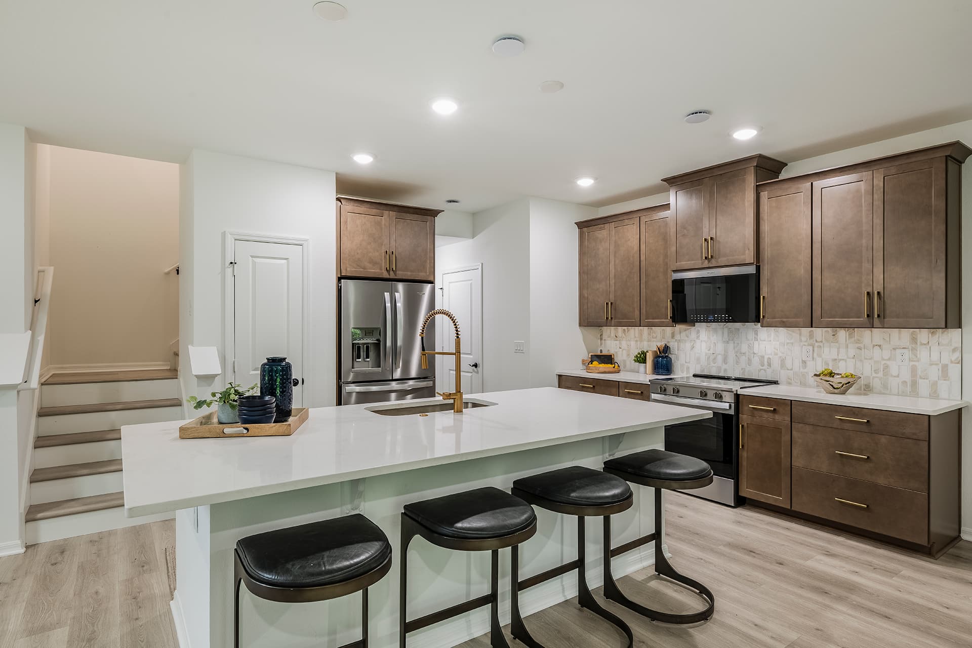 kitchen with brown cabinets and quartz countertops