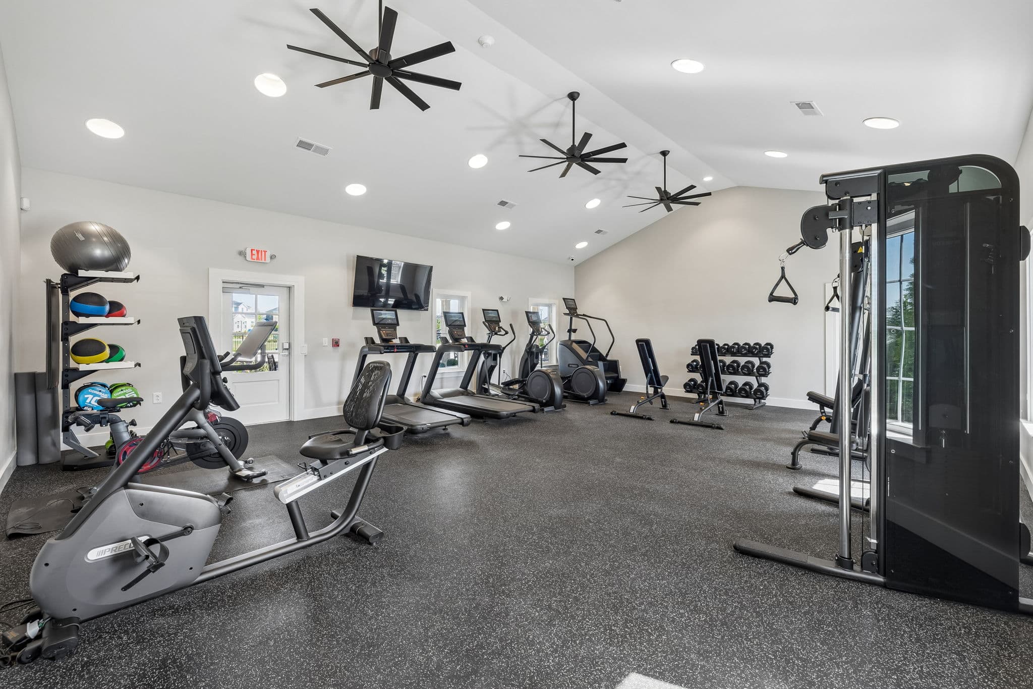 fitness center with treadmill, stairmaster, and weights