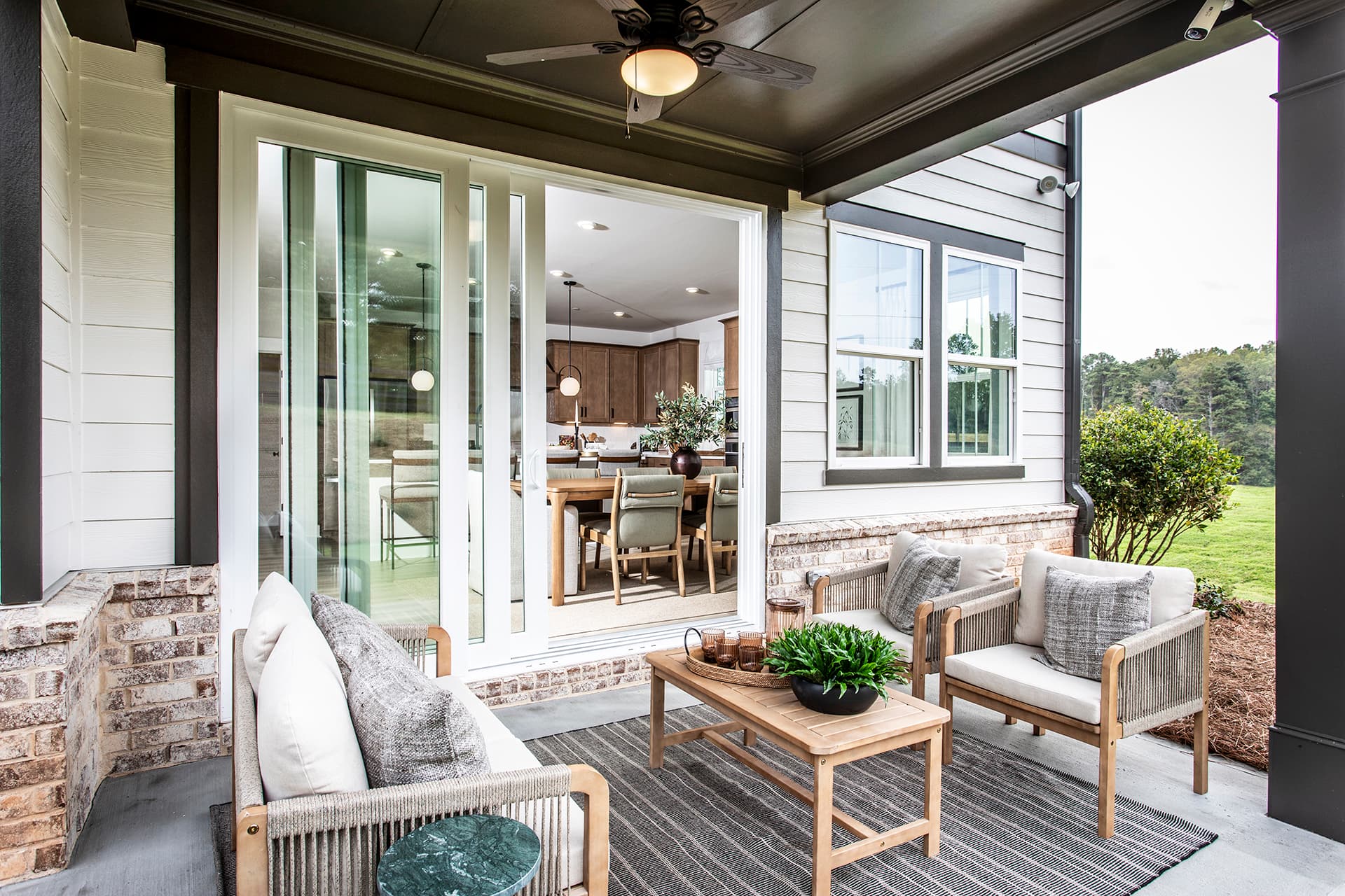covered patio with patio furniture and views into home
