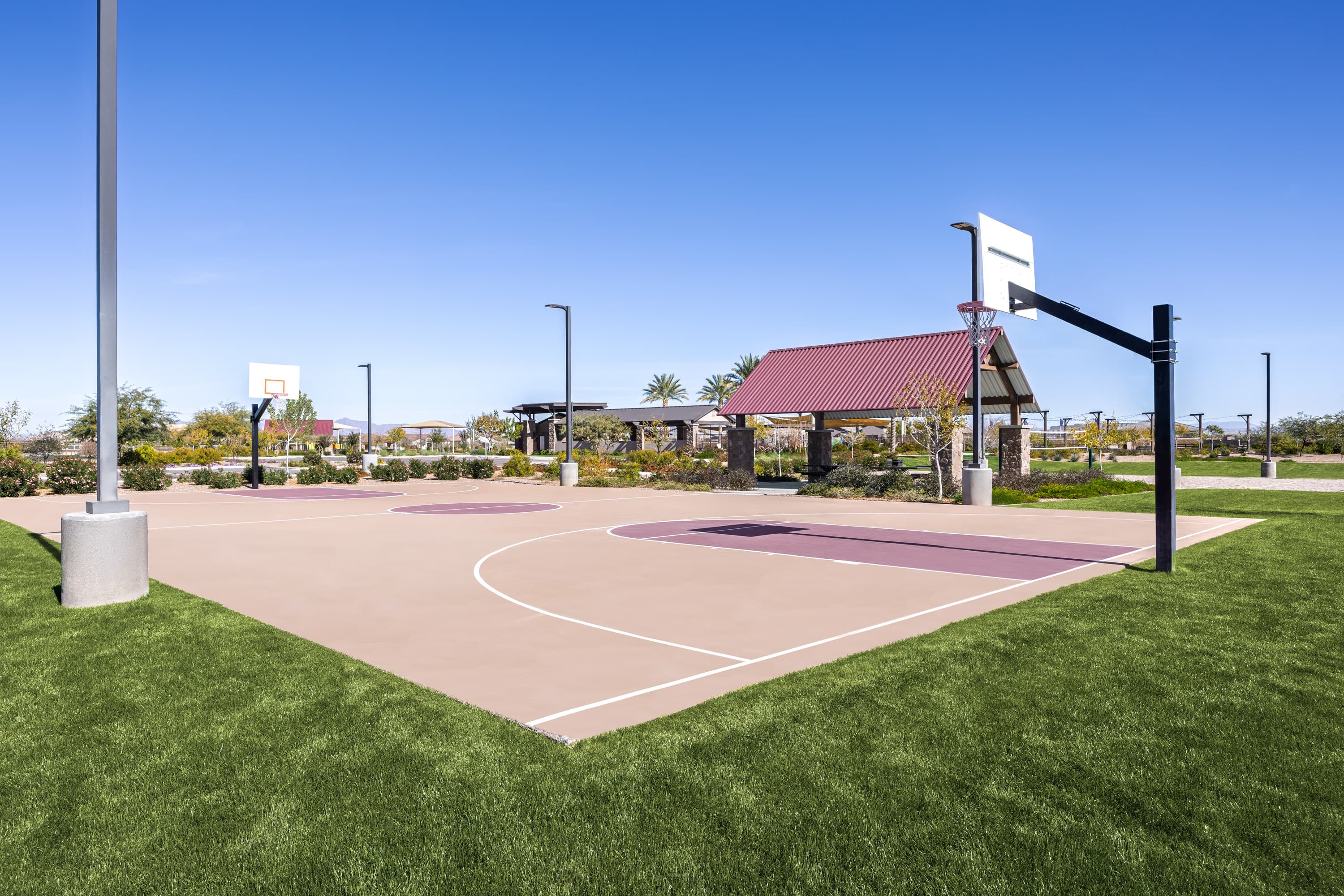 basketball court with green grass surrounding it