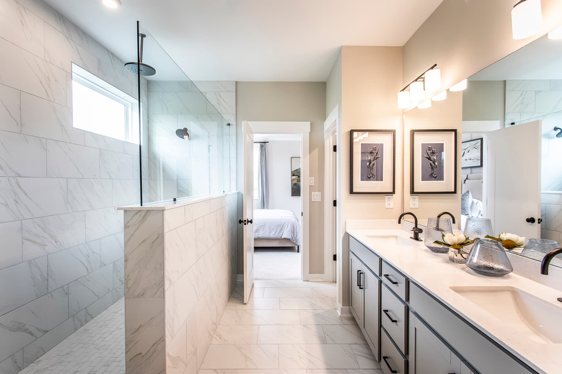 primary bathroom with dual vanity & gray cabinets