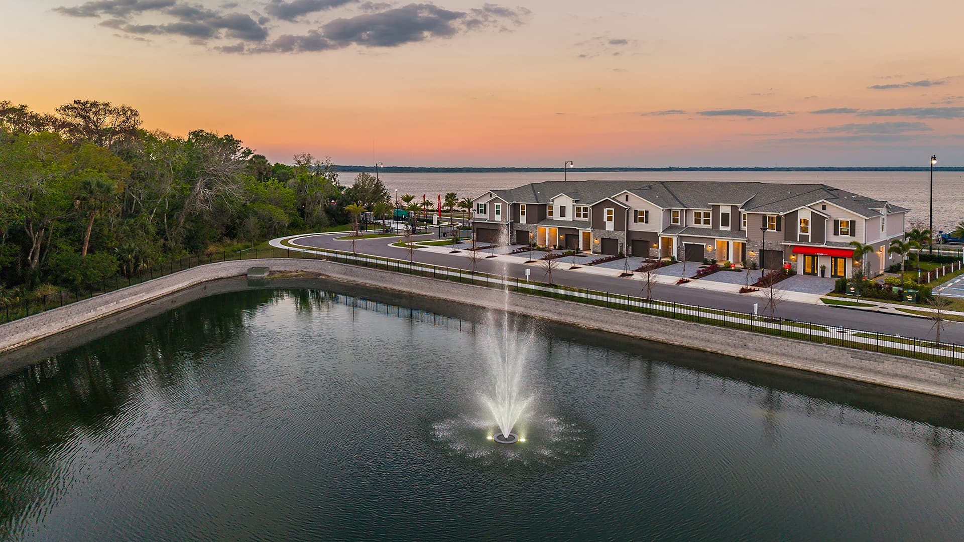 exterior of townhome building with sunset