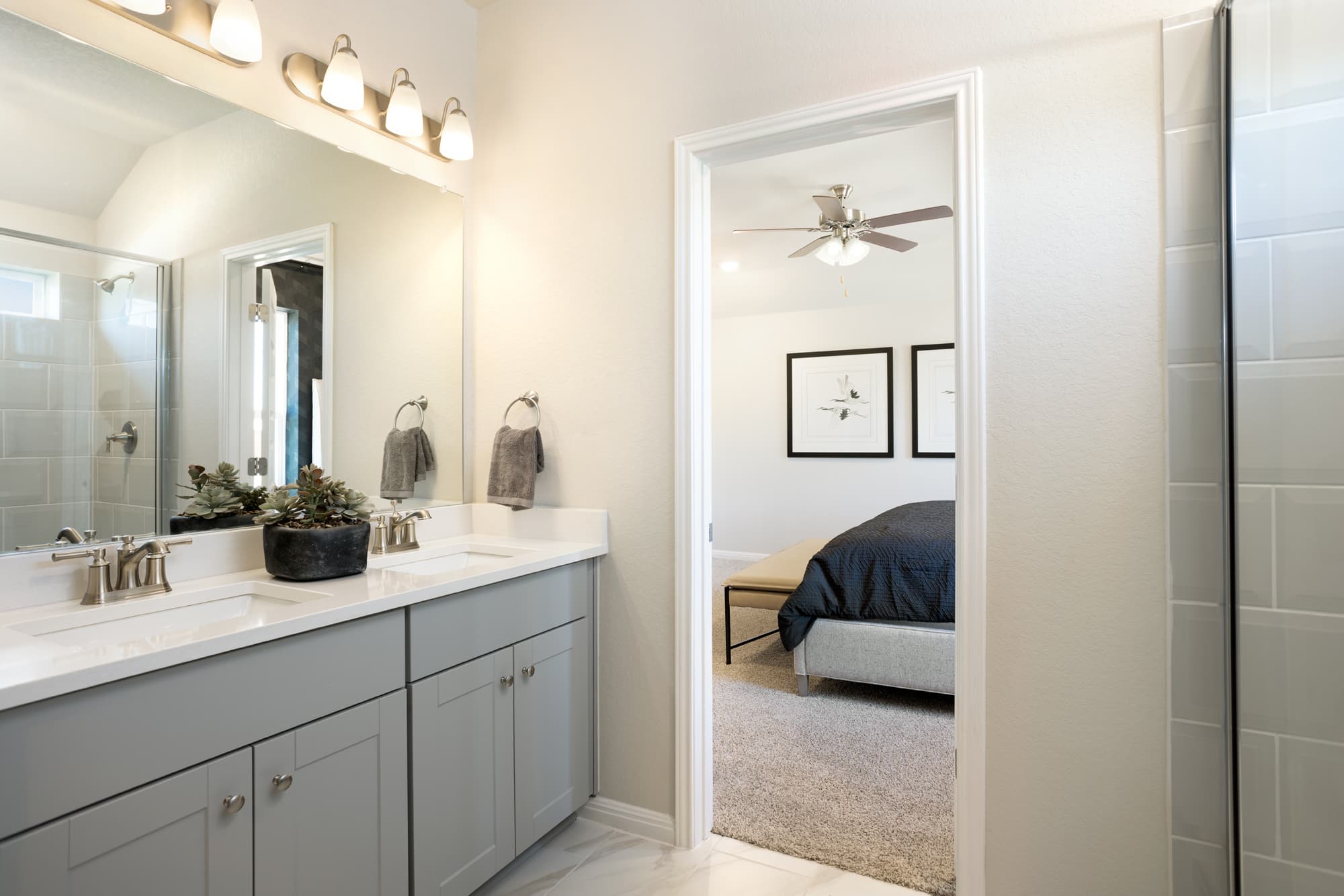 bathroom with white tile and gray cabinets