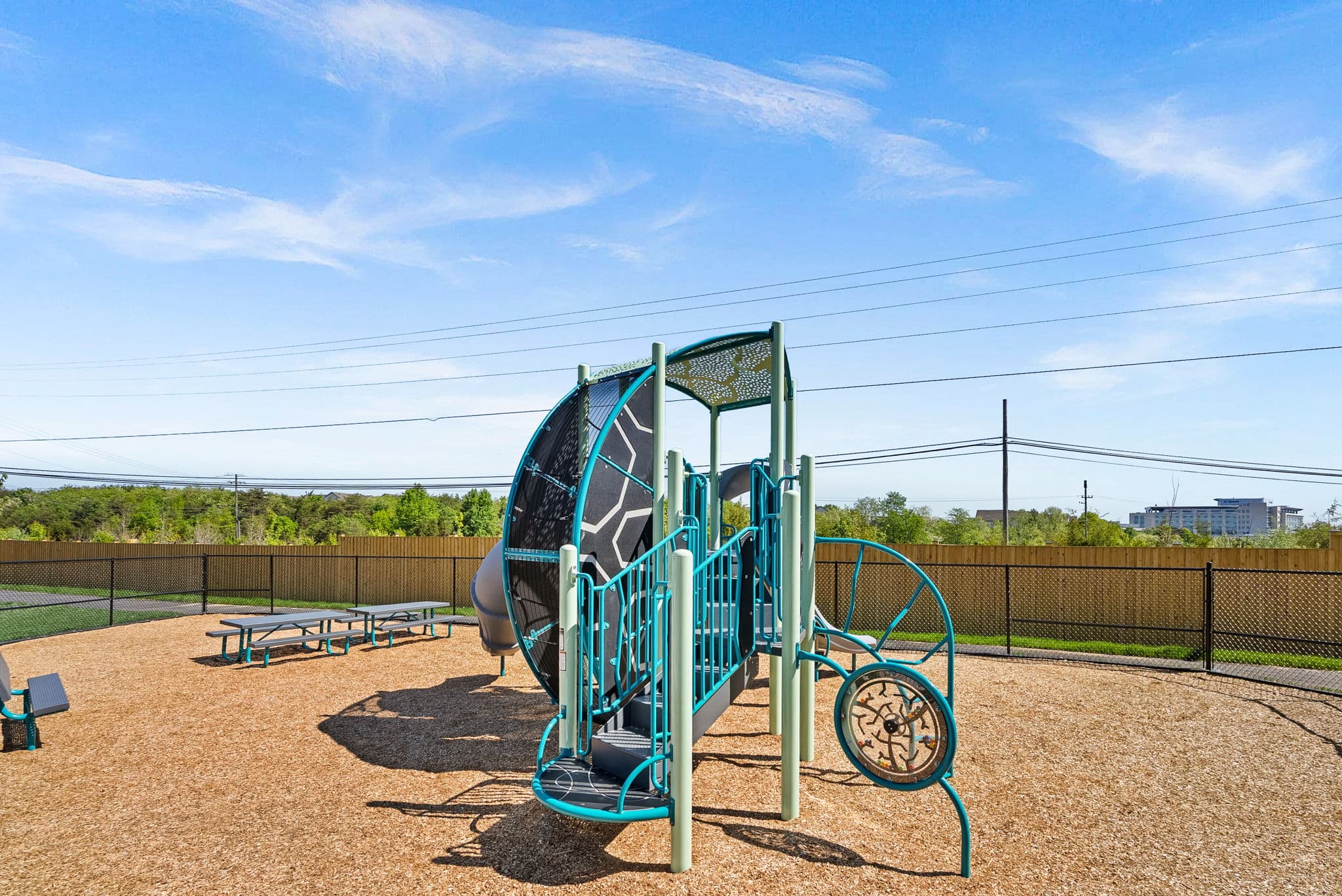 climbing structure and picnic tables