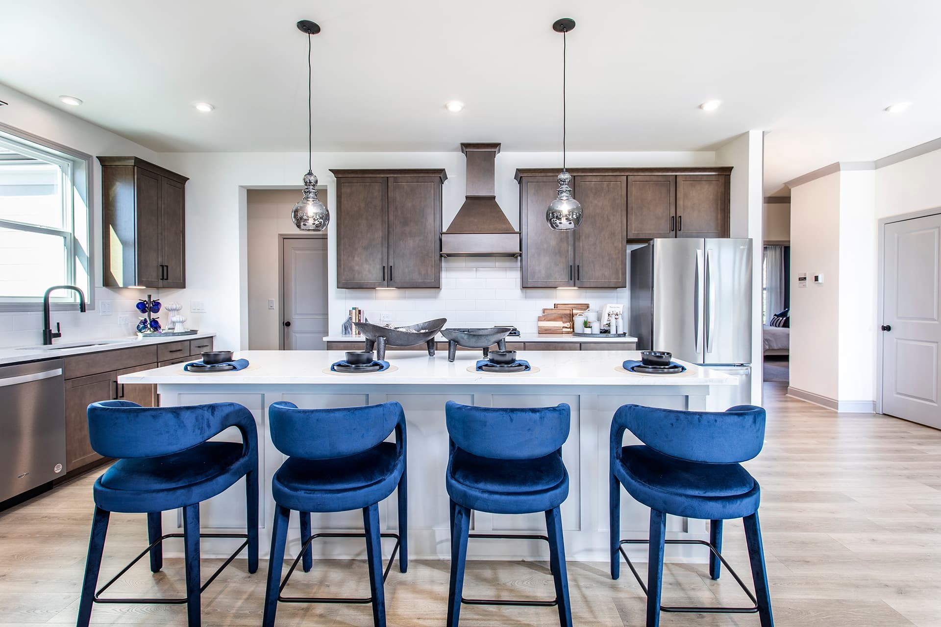 kitchen with brown cabinets & quartz counters