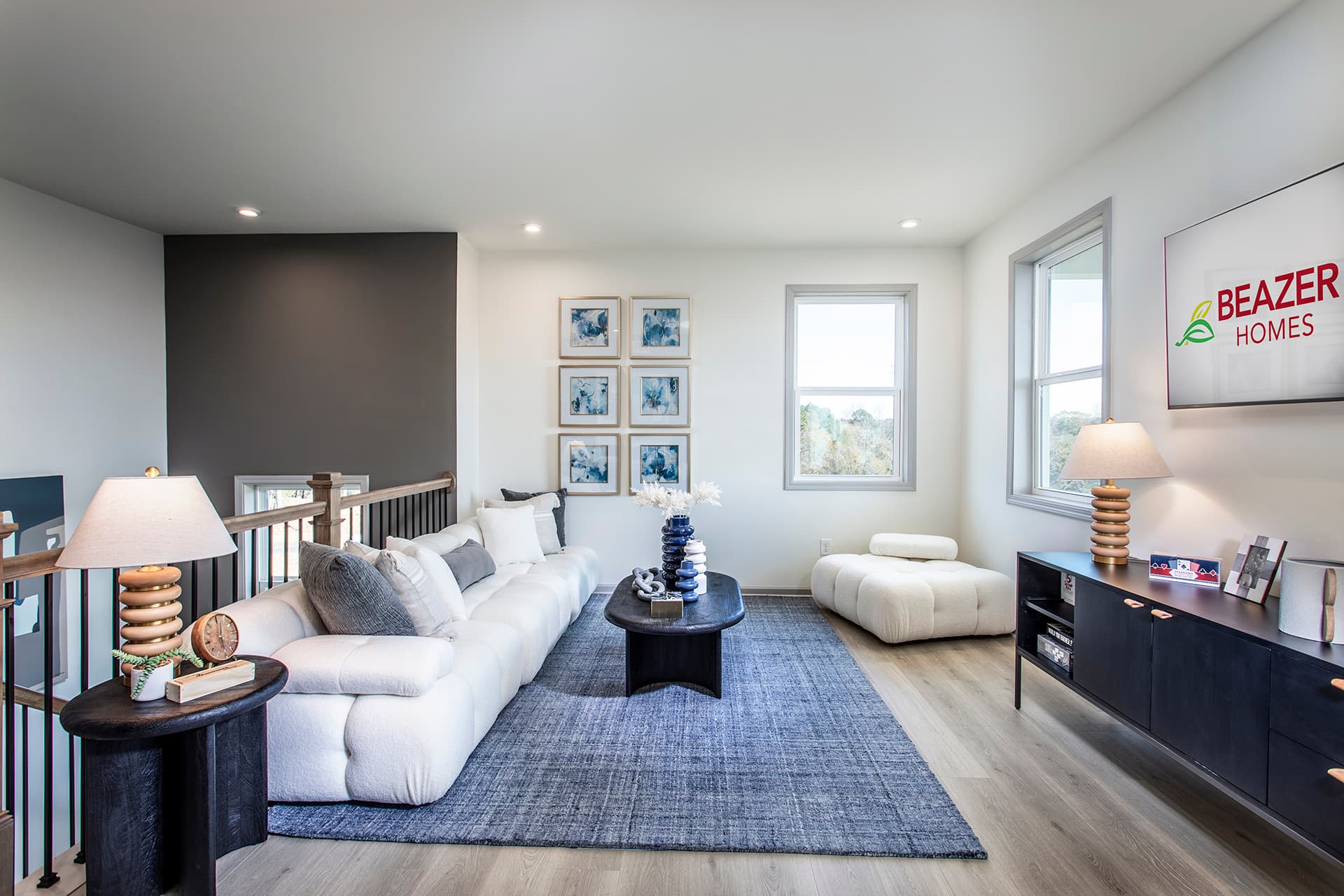 upstairs loft with plank flooring & white couches