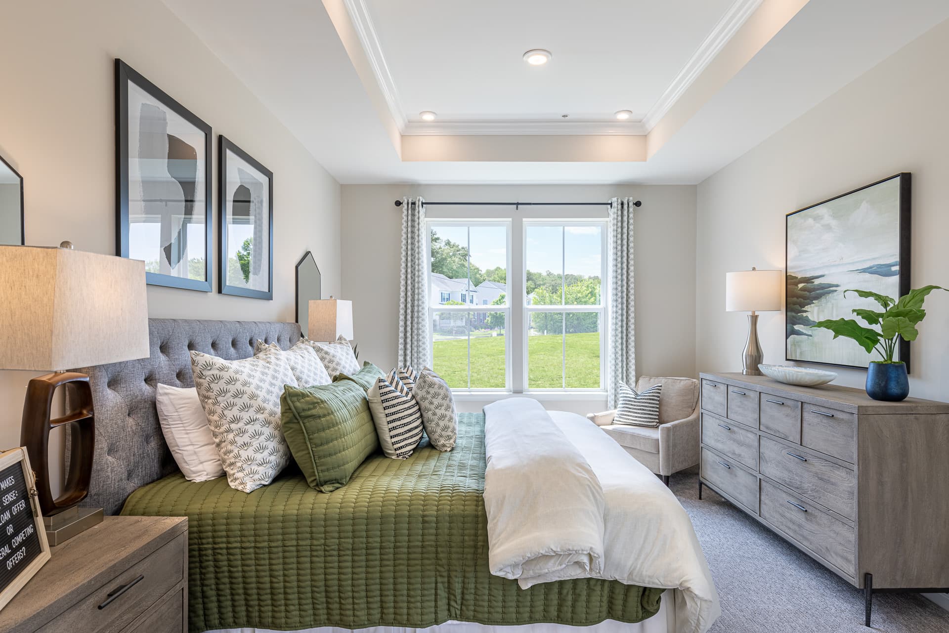 1st-floor primary suite with a tray ceiling