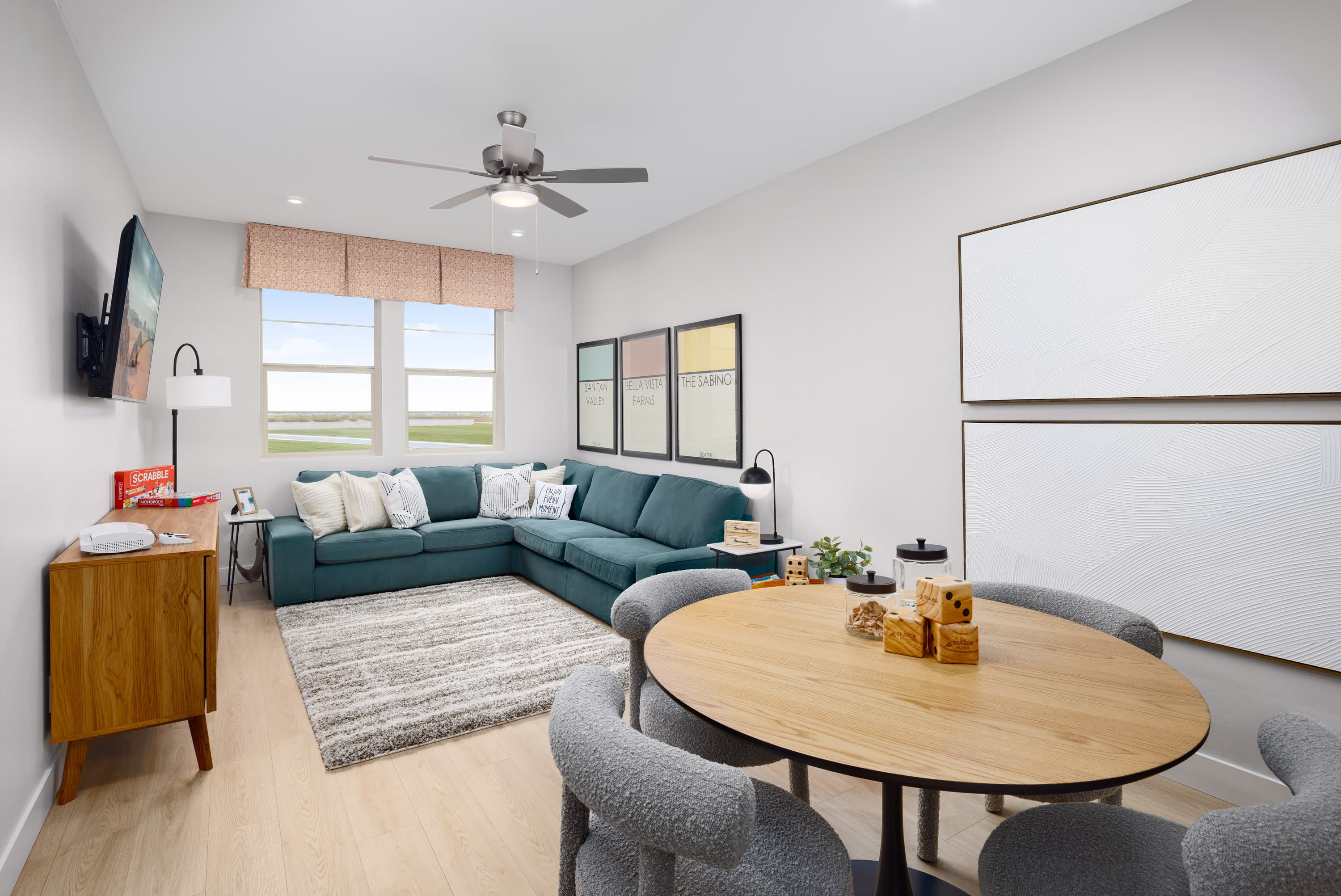 loft being used as a second great room and entertainment center with a large green couch and tv