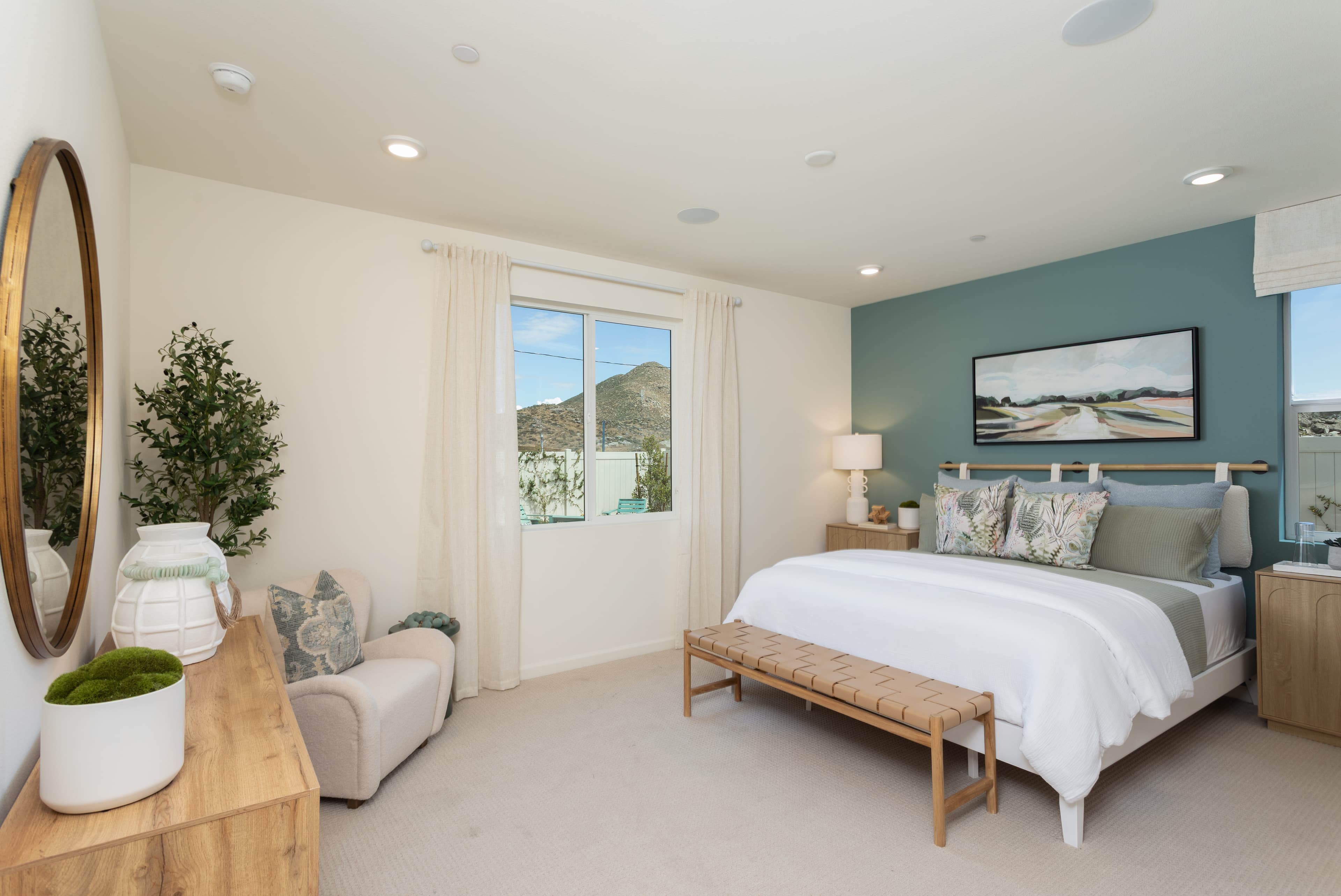 primary bedroom with neutral floors and large windows