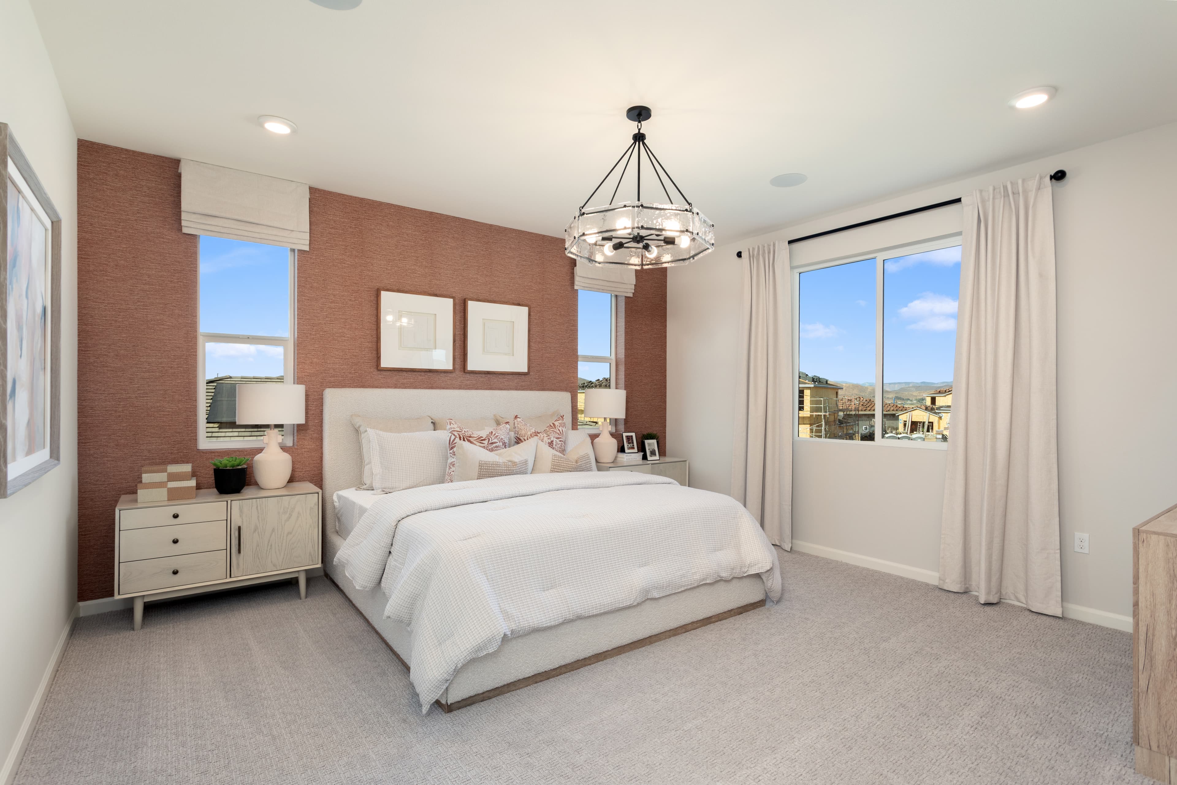 primary bedroom with neutral floors and large windows