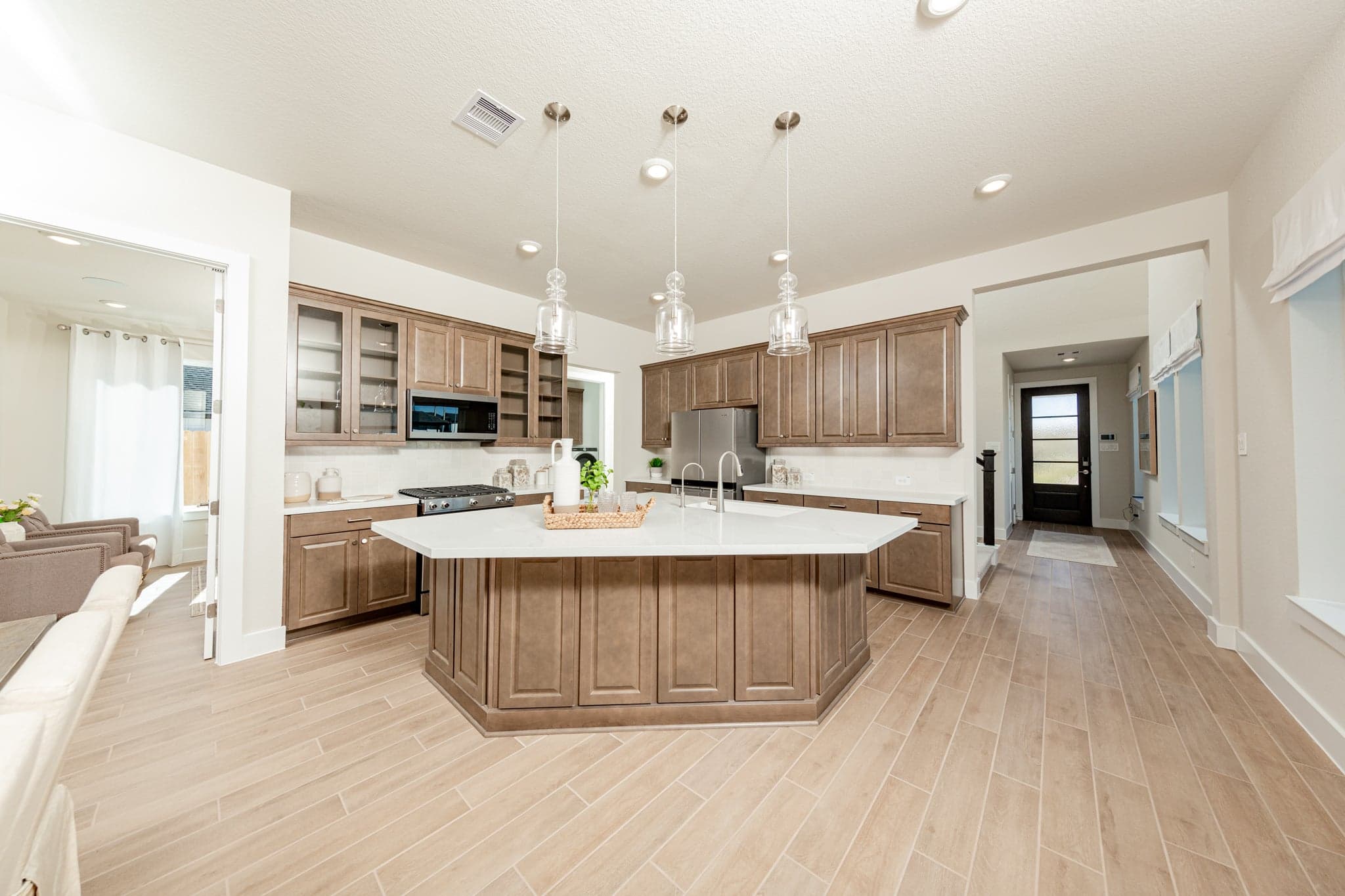 spacious kitchen with brown cabinets and hardwood flooring
