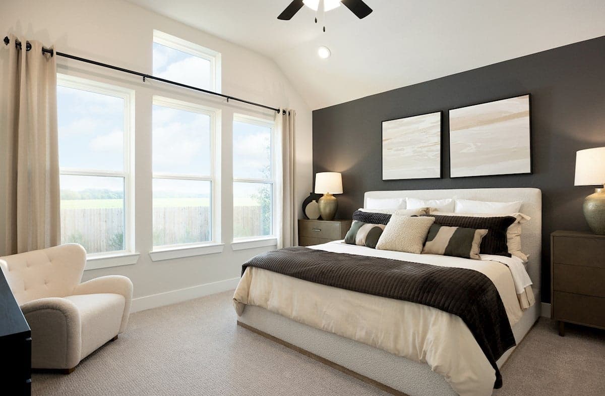 bedroom with carpet, windows & a ceiling fan