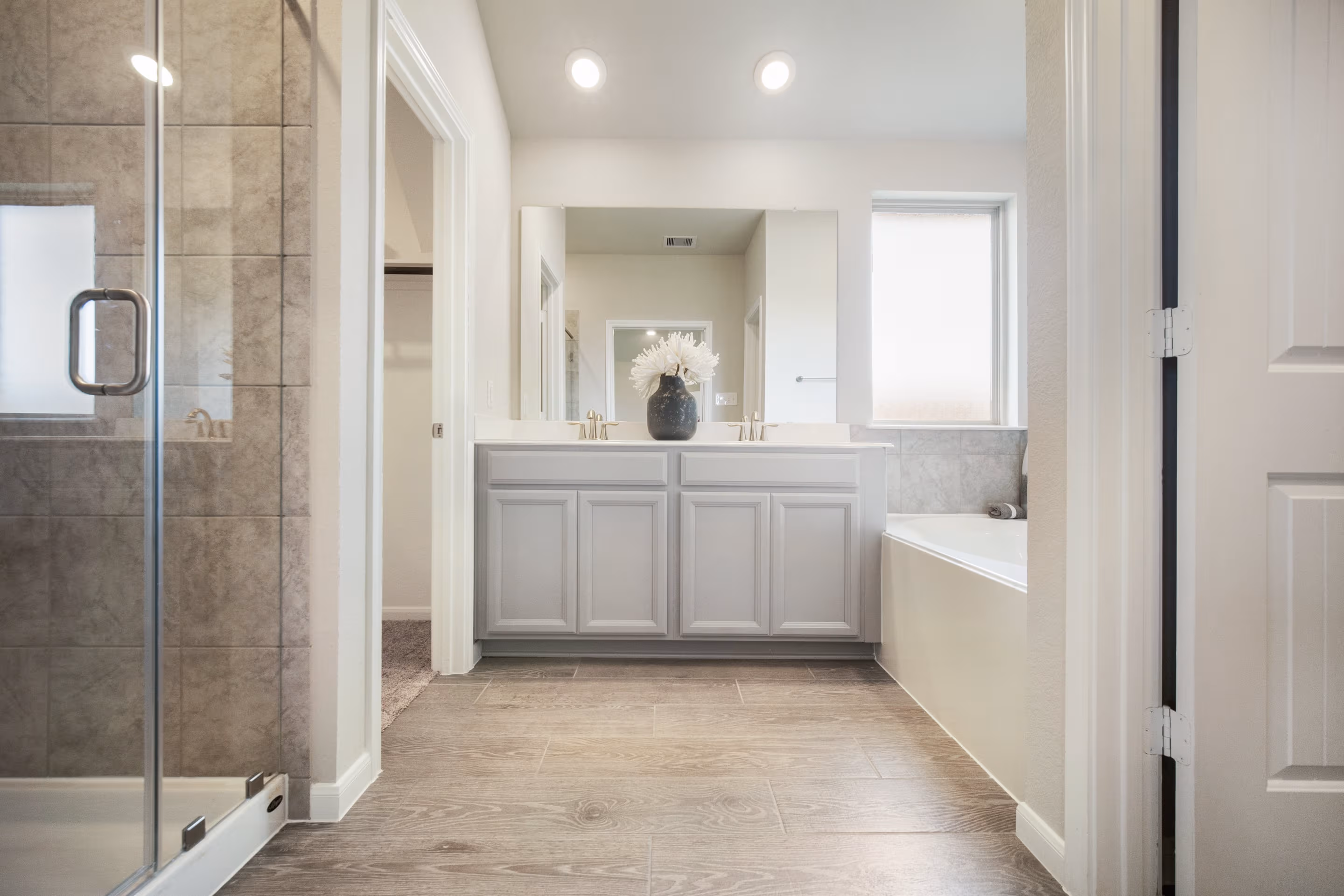 primary bathroom with tub and shower