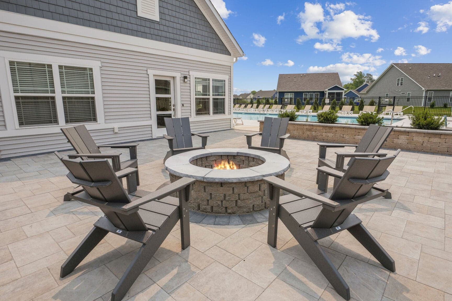 firepit with adirondack chairs around it
