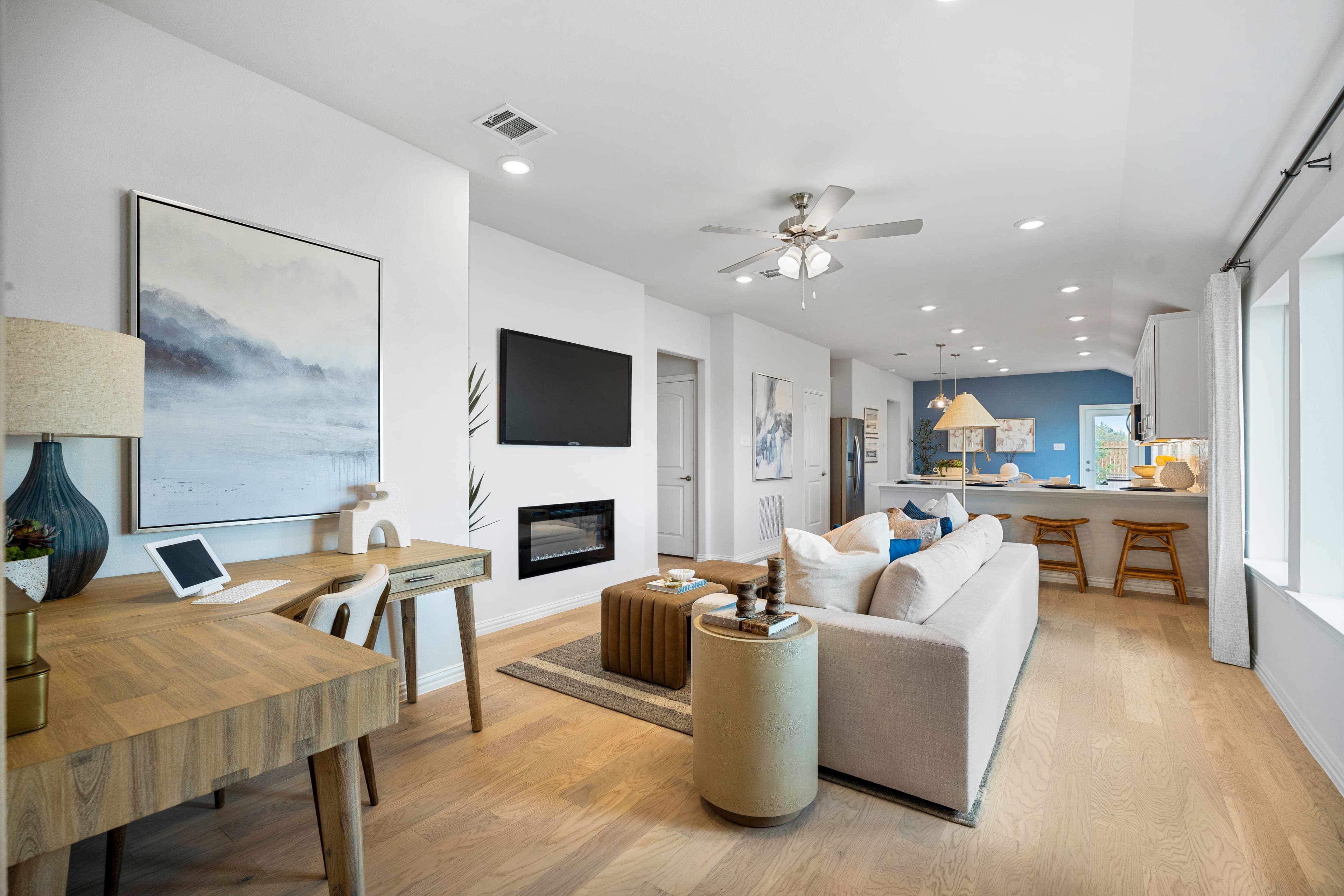open great room with wood floors and fireplace