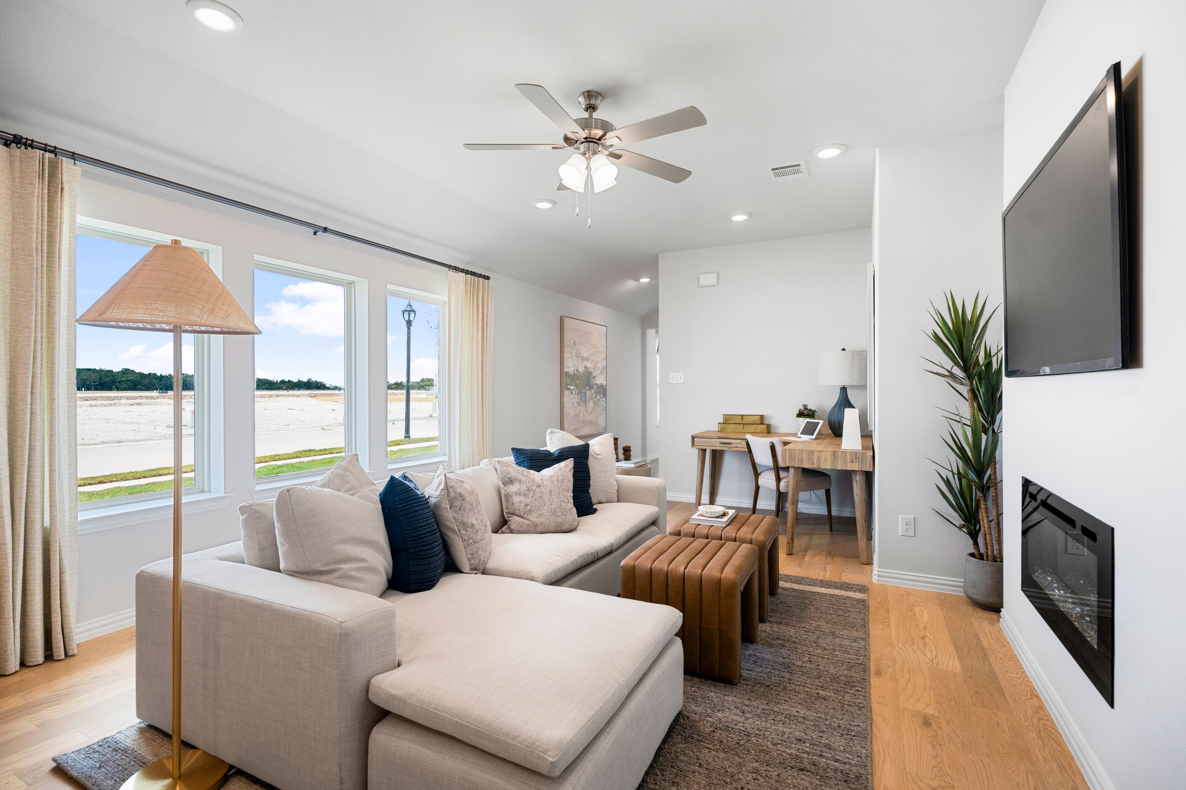open great room with wood floors and ceiling fan