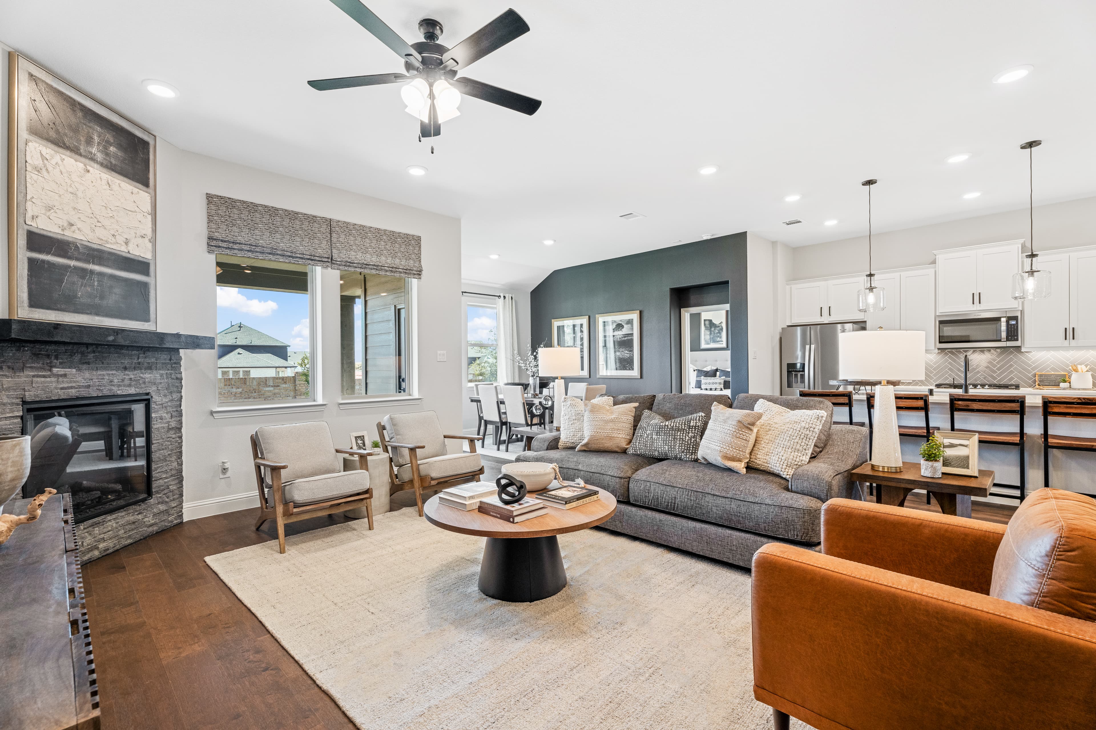 open great room with wood floors and fireplace