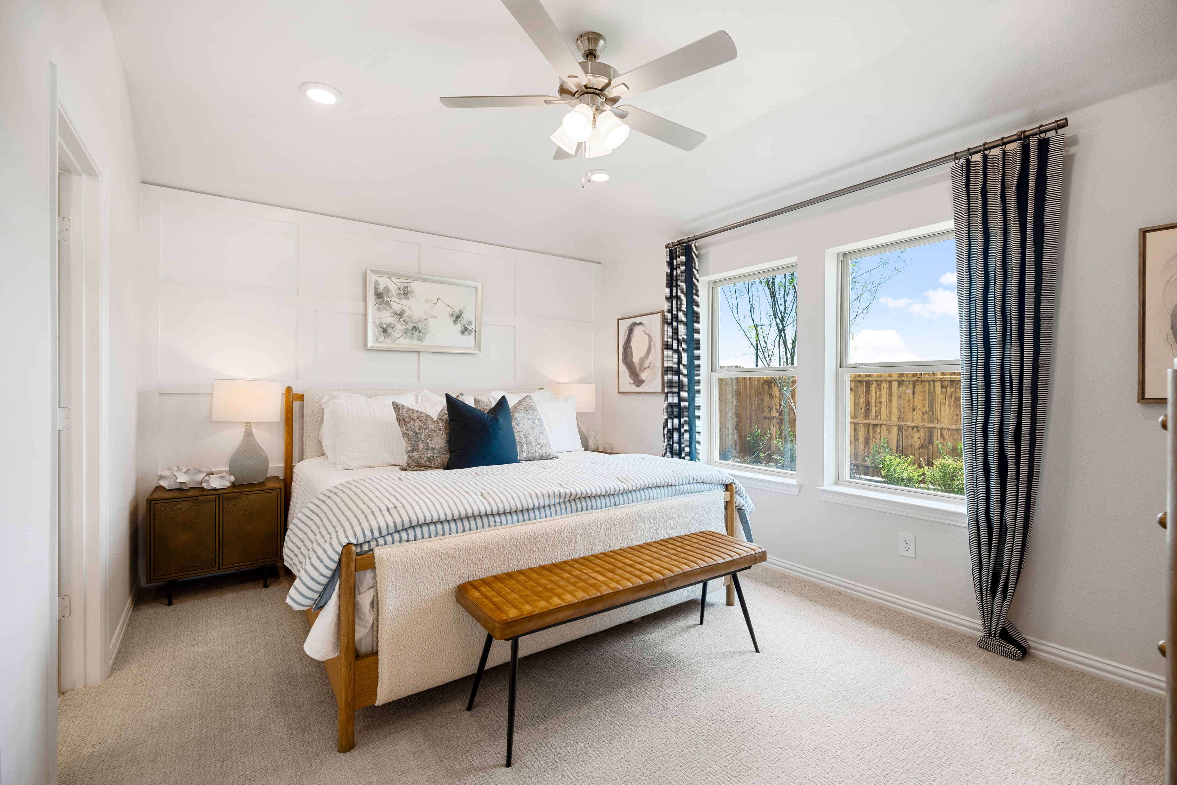 primary bedroom with carpet and windows
