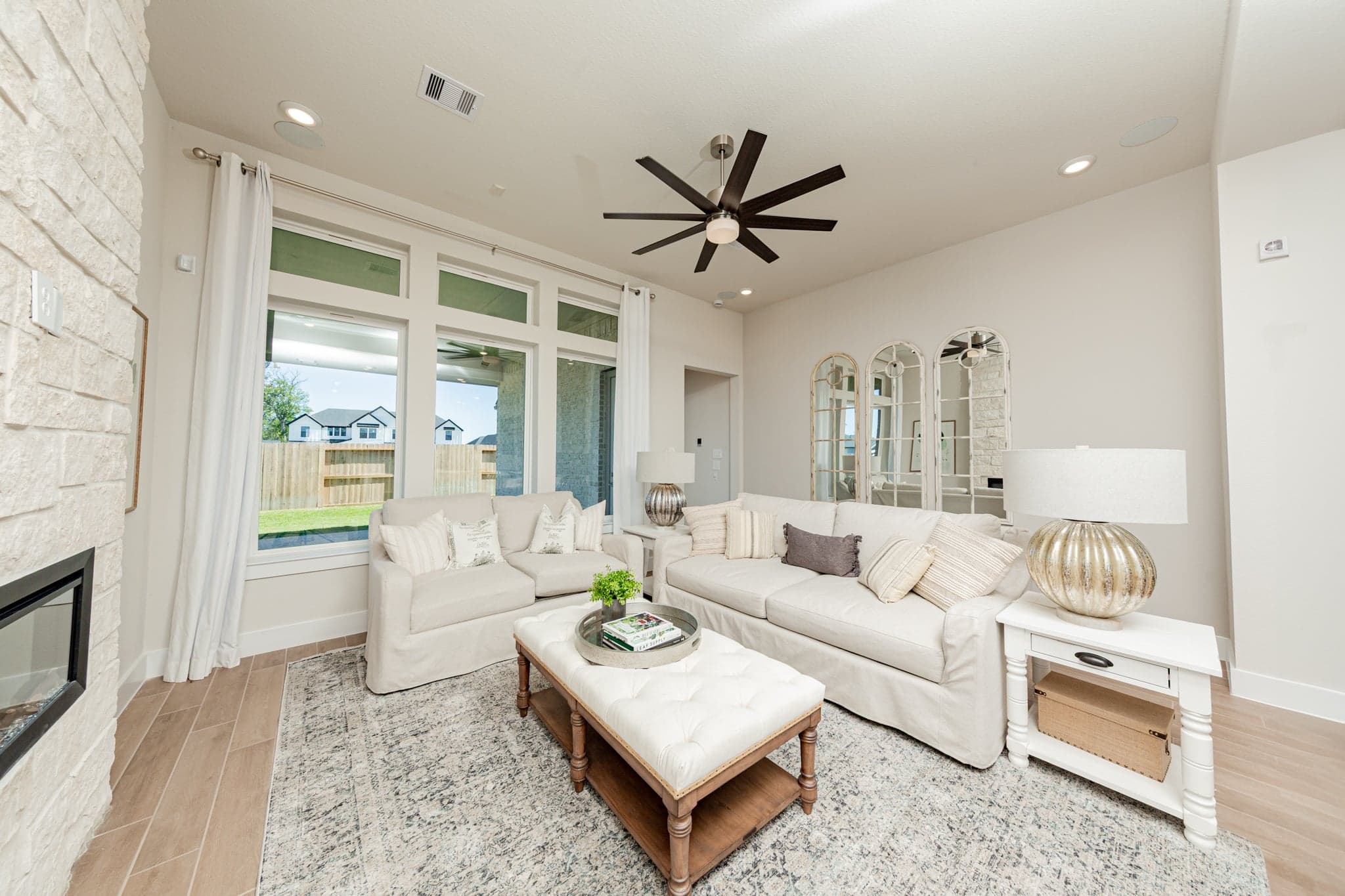 spacious great room with high ceilings and windows